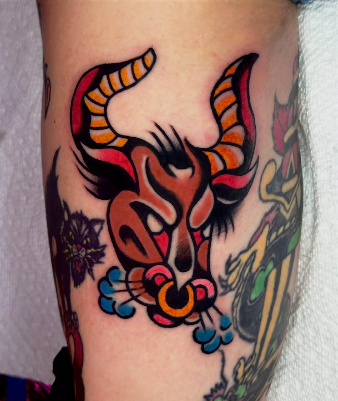 Bull head American traditional tattoo on the forearm by Butz Tattoos