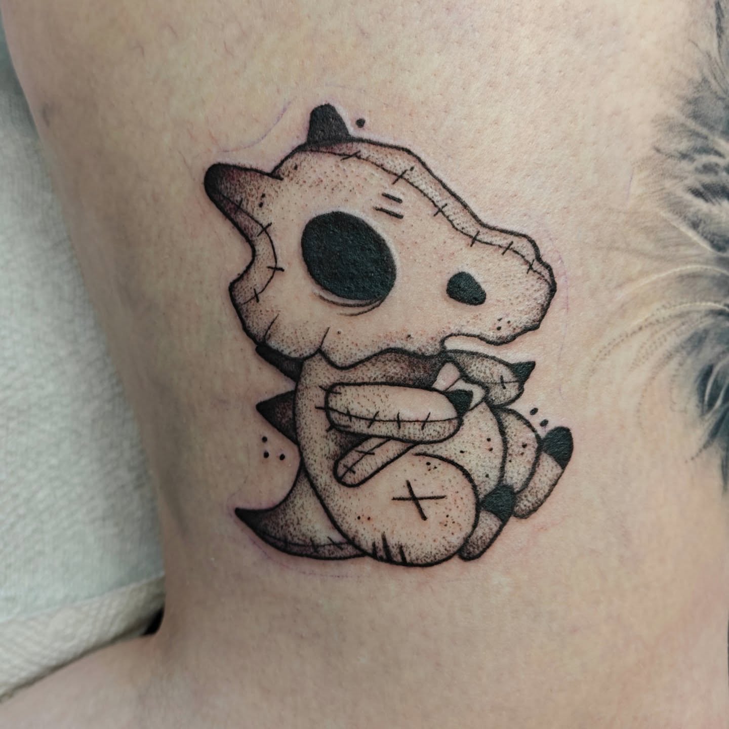 Stuffed animal dotwork tattoo on the neck by Meg