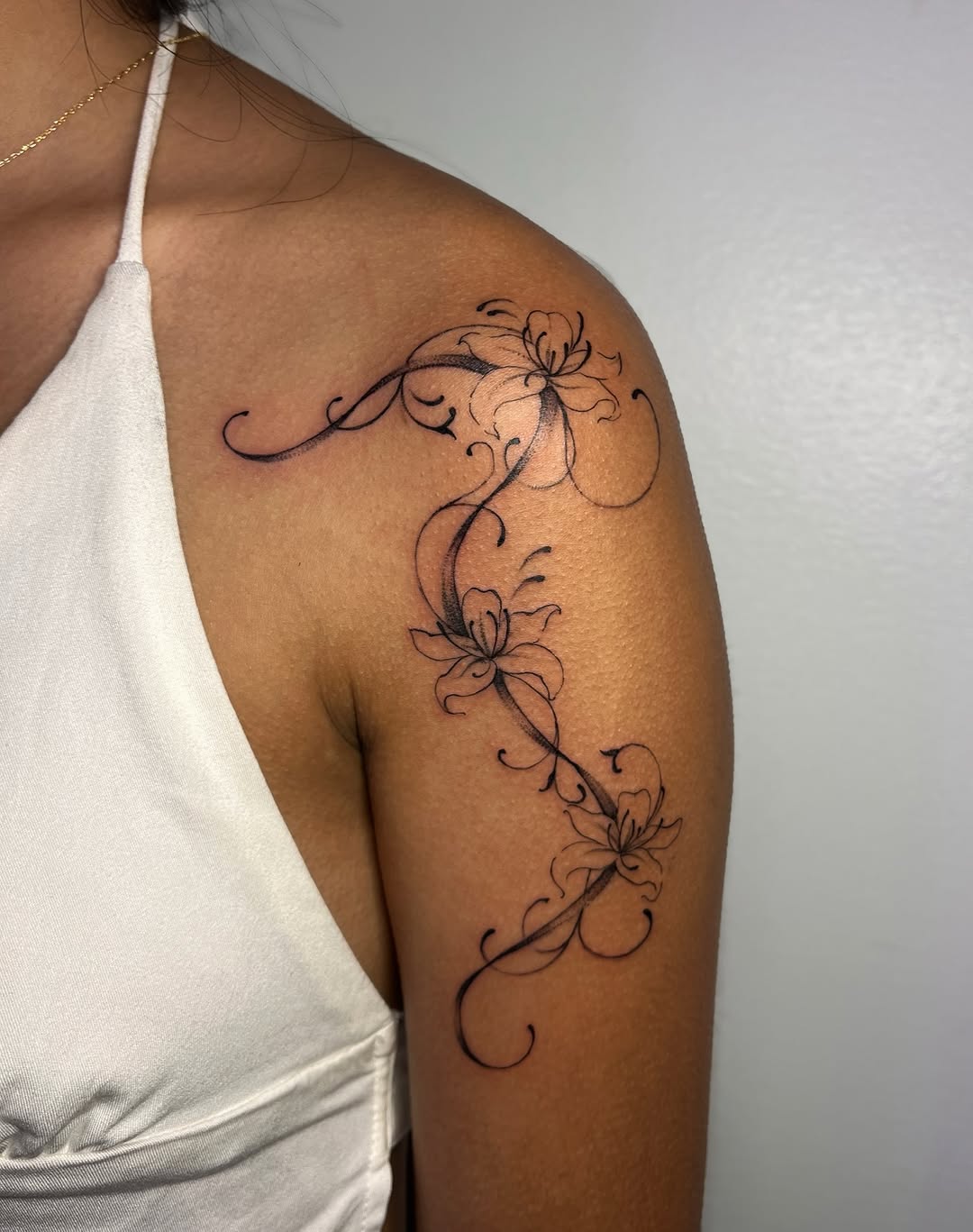 Floral vine fine line tattoo on the shoulder by MK