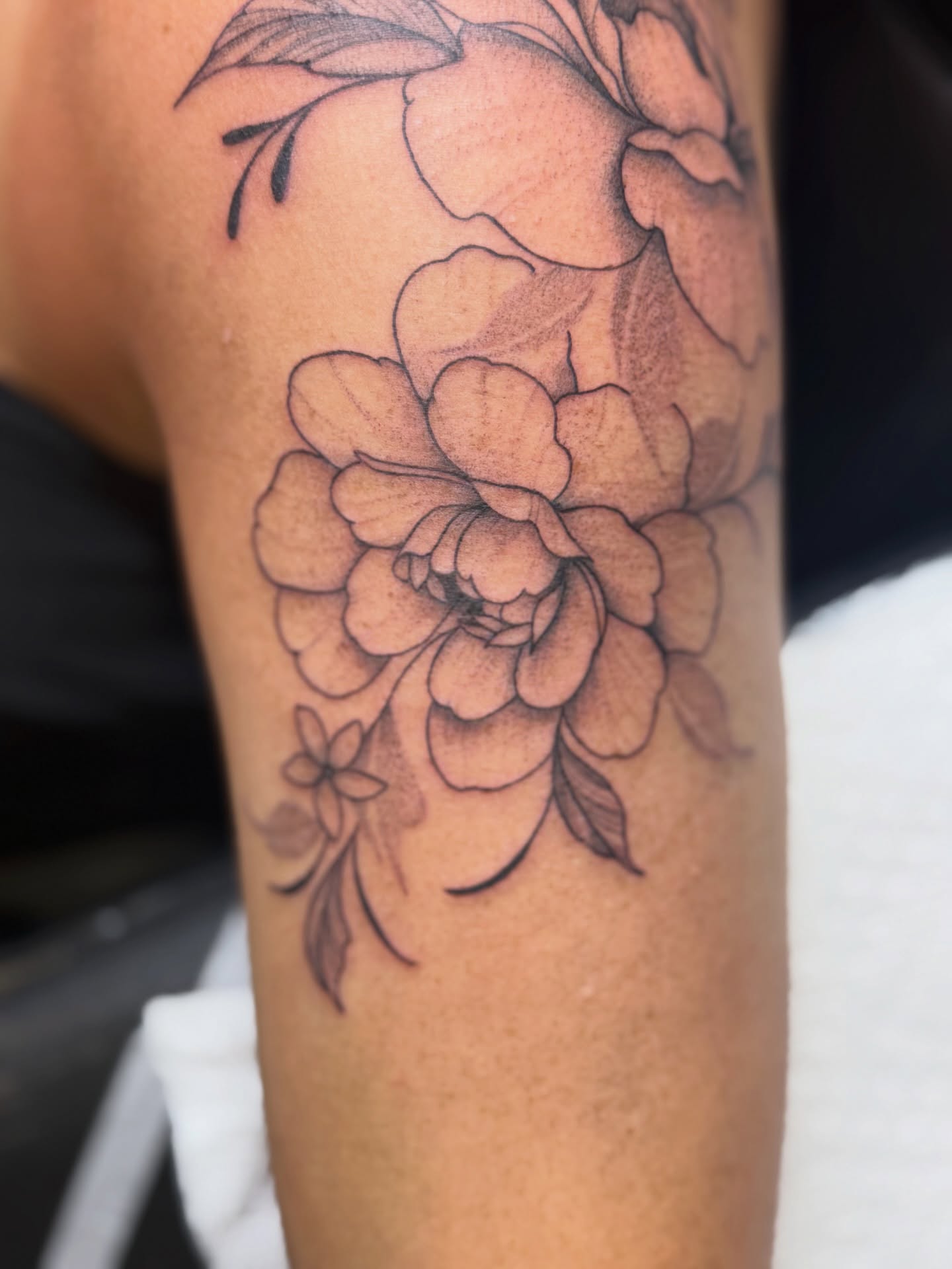 Peony black and grey tattoo on the forearm by WhoisLaineyTattoos