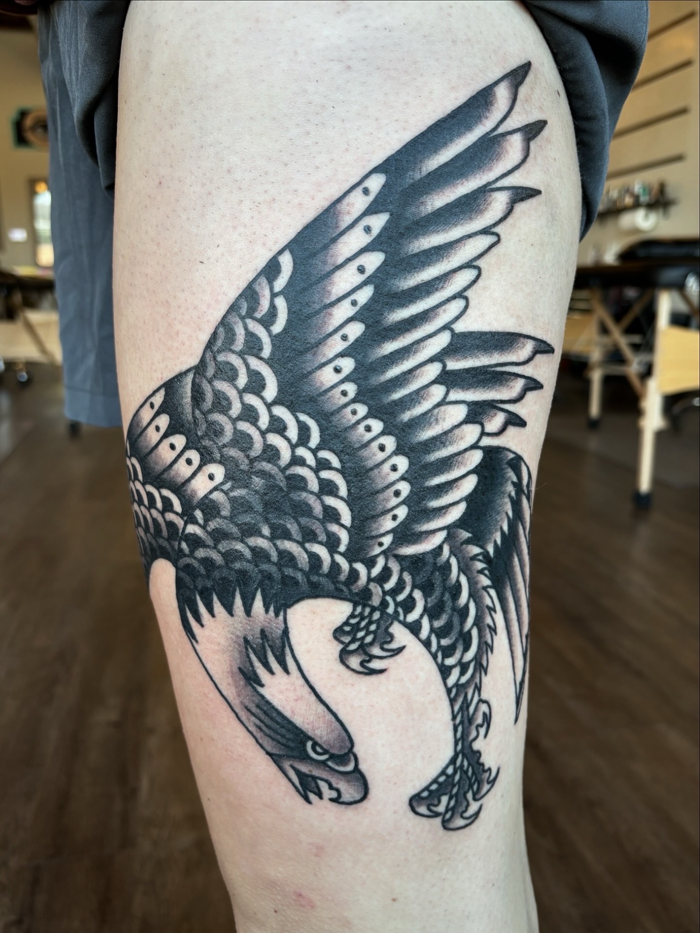 Eagle black and grey tattoo on the thigh by Jeff Slack