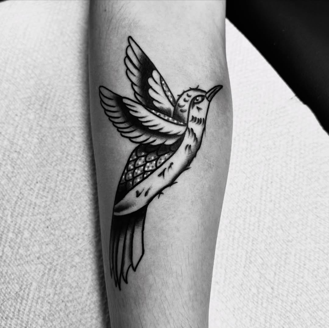 Bird black and grey tattoo on the forearm by Brandon