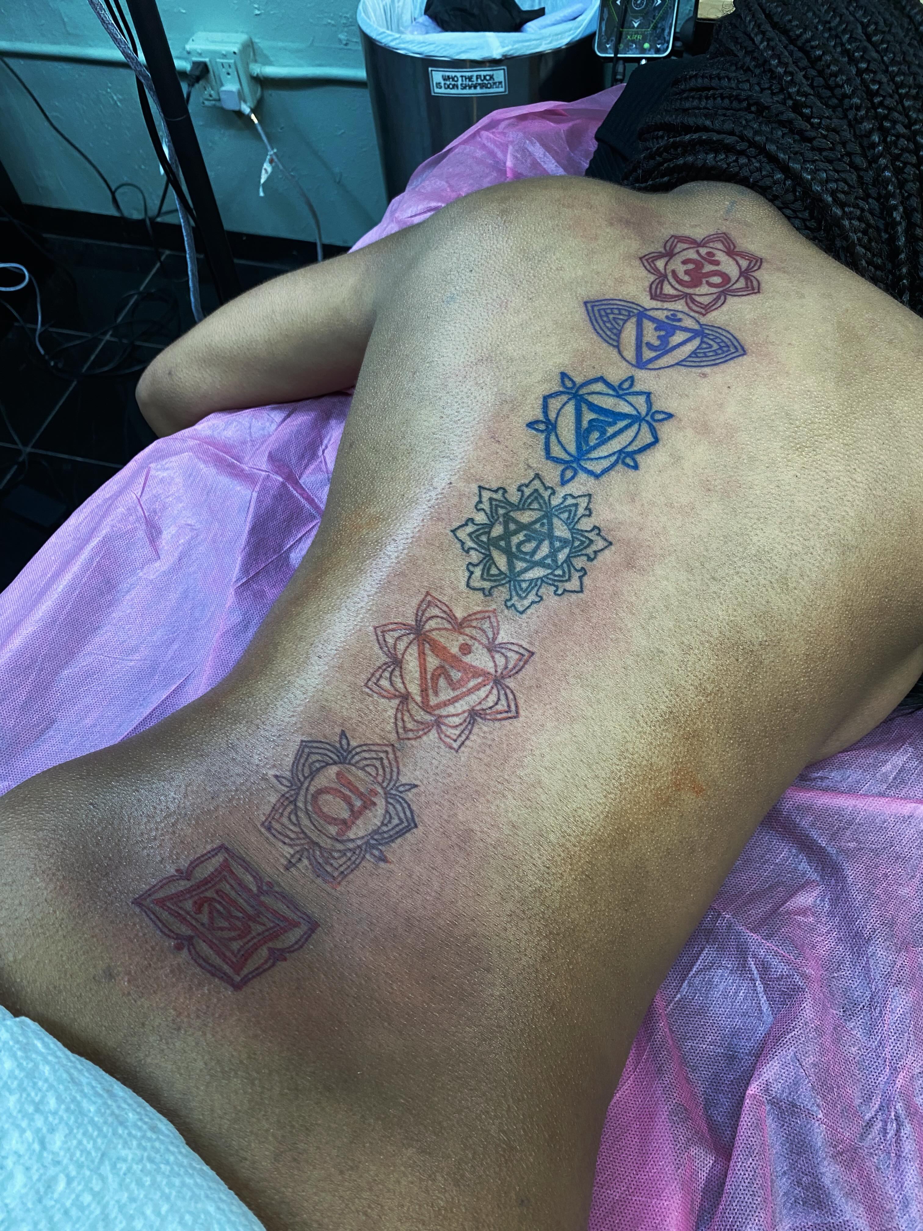 Chakra symbols geometric tattoo on the back by Houston tattoo artist