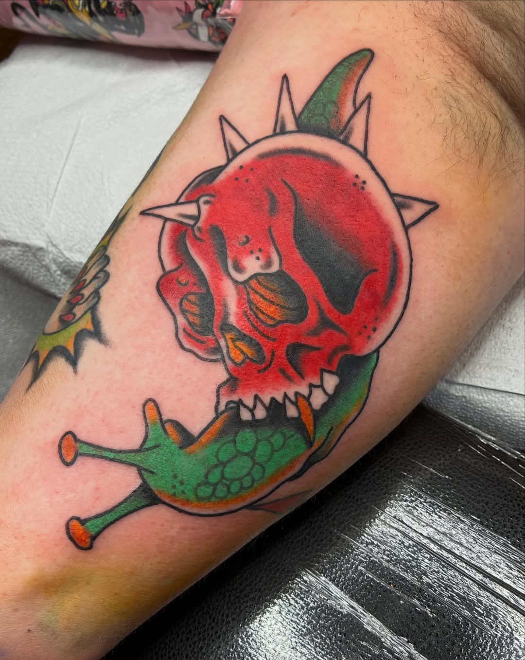 Skull with snail American traditional tattoo on the forearm by @spicy.curry.tattoos