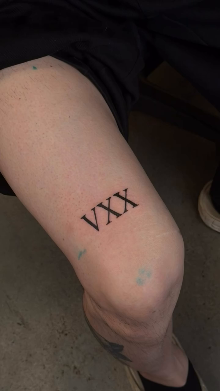 Roman numerals VXX tattoo on the leg by Lxx.