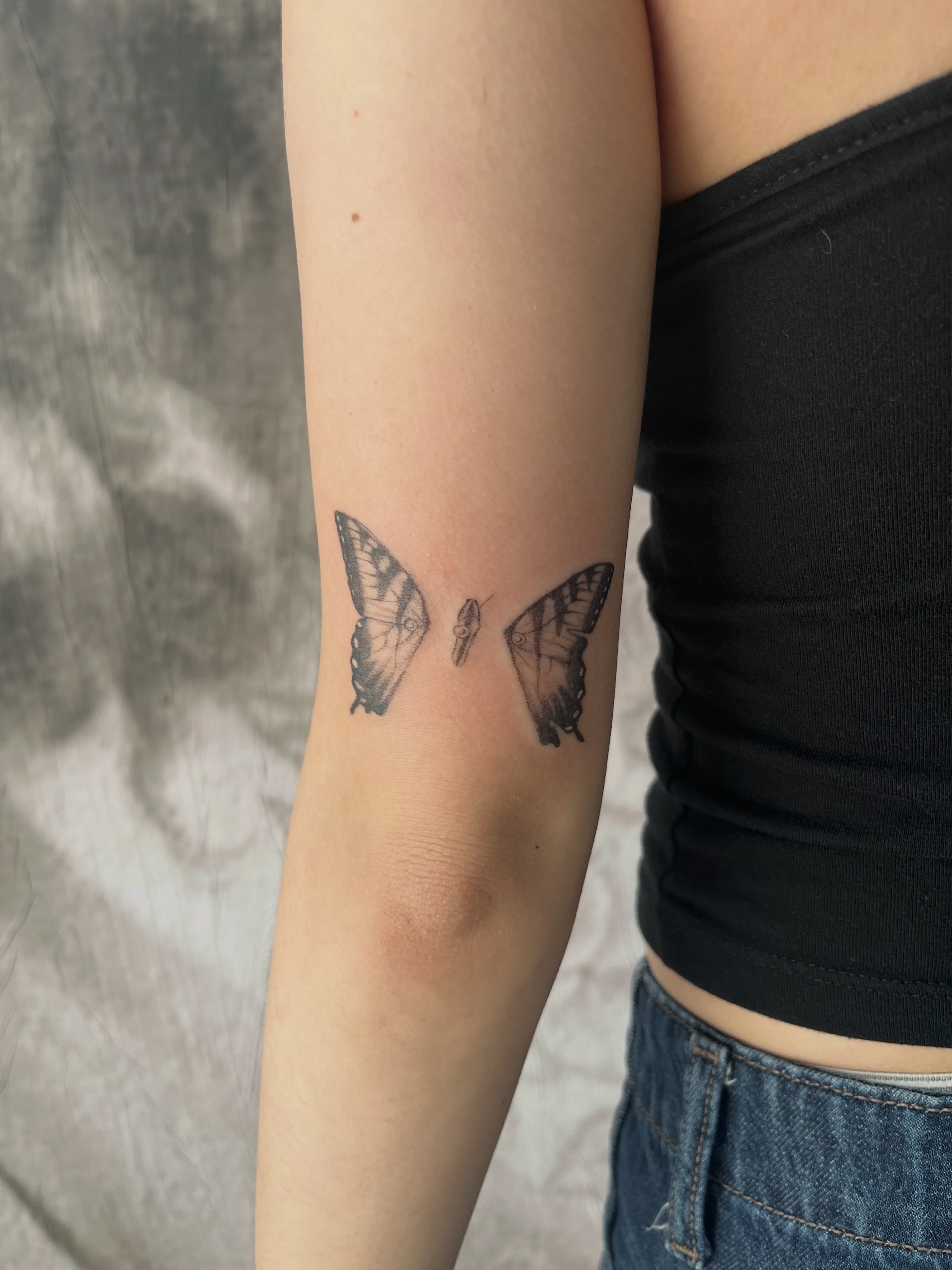 Butterflies black and grey tattoo on the forearm by Kyra Monterrosa