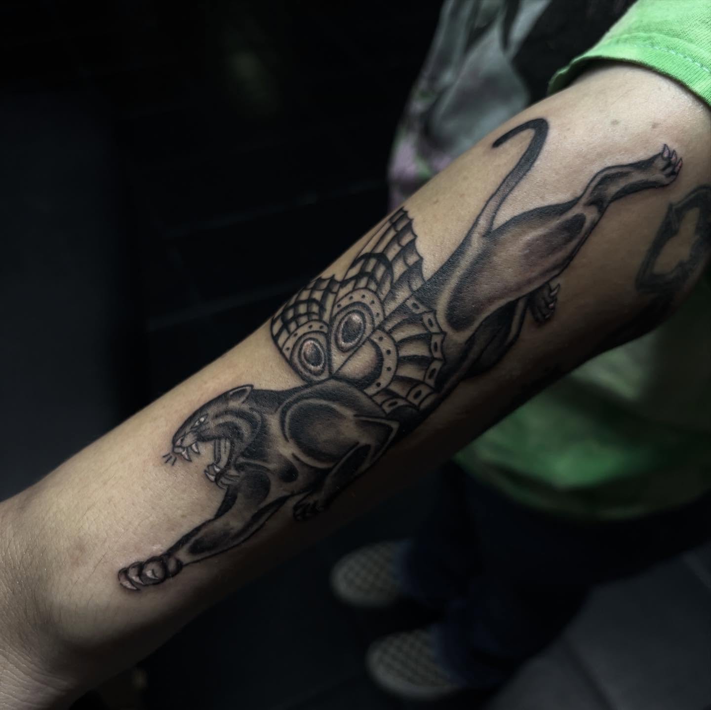 Panther with wings geometric tattoo on the forearm by suzie