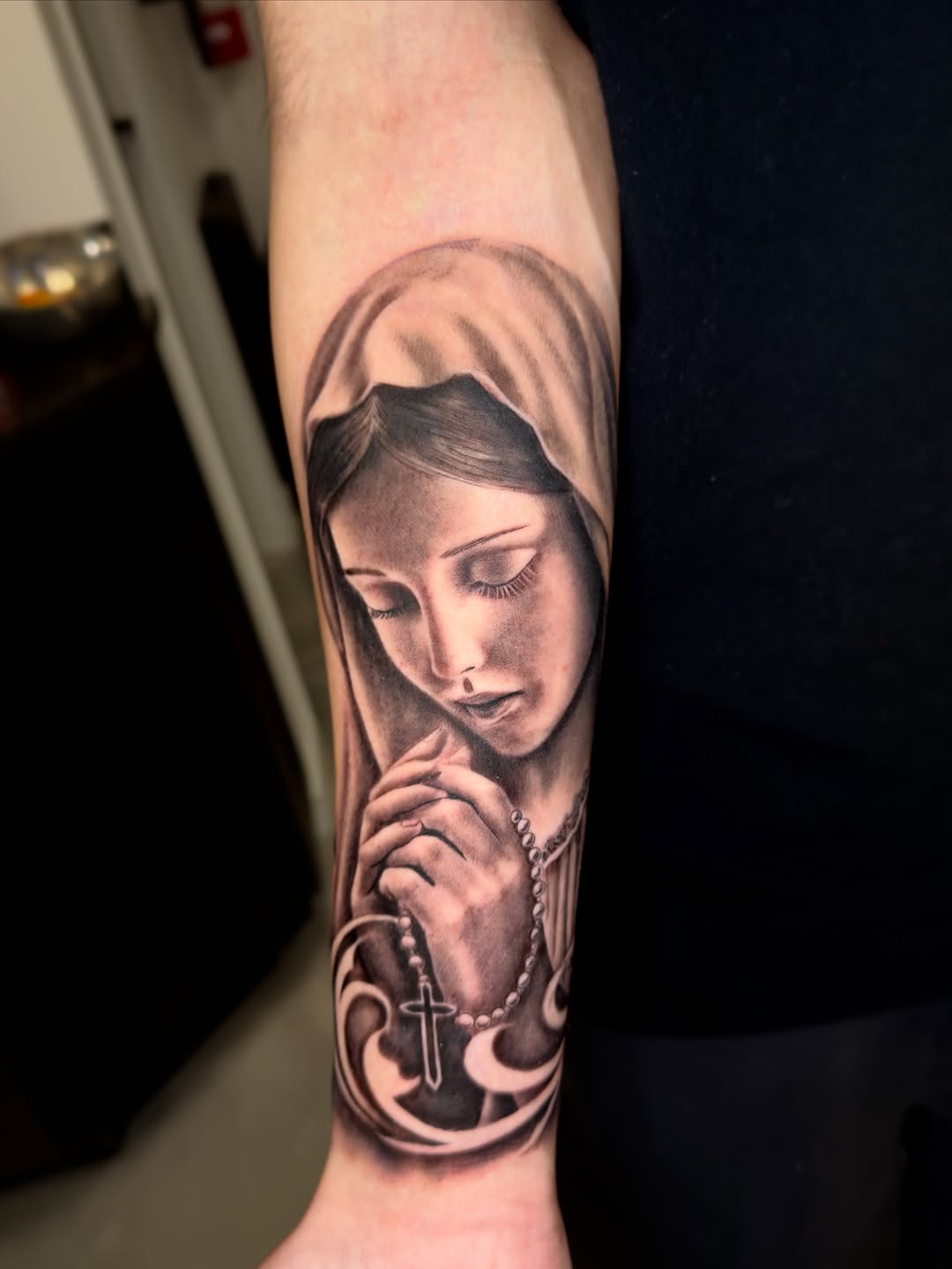 Virgin Mary with rosary Chicano tattoo on the forearm by Brandon Patino