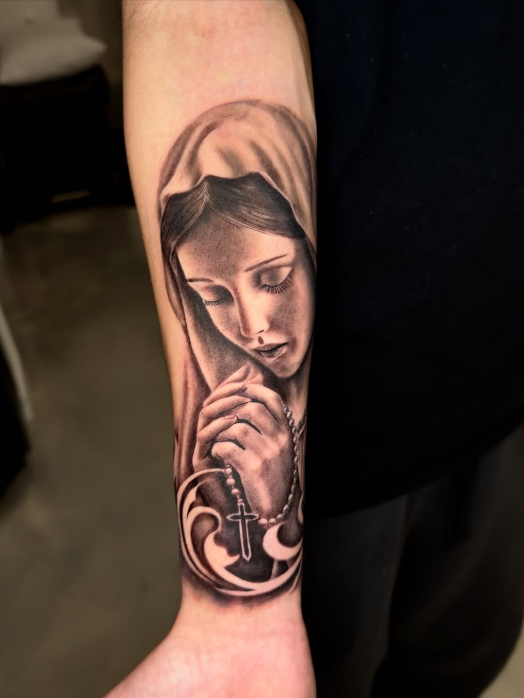 Virgin Mary with rosary Chicano tattoo on the forearm by Brandon Patino