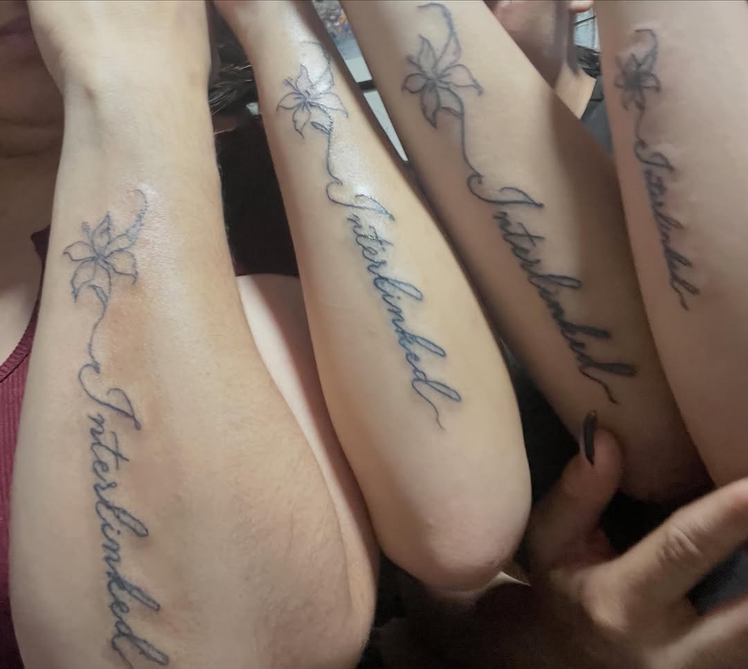 Flower and script lettering fine line tattoo on the forearm by The feminine ink