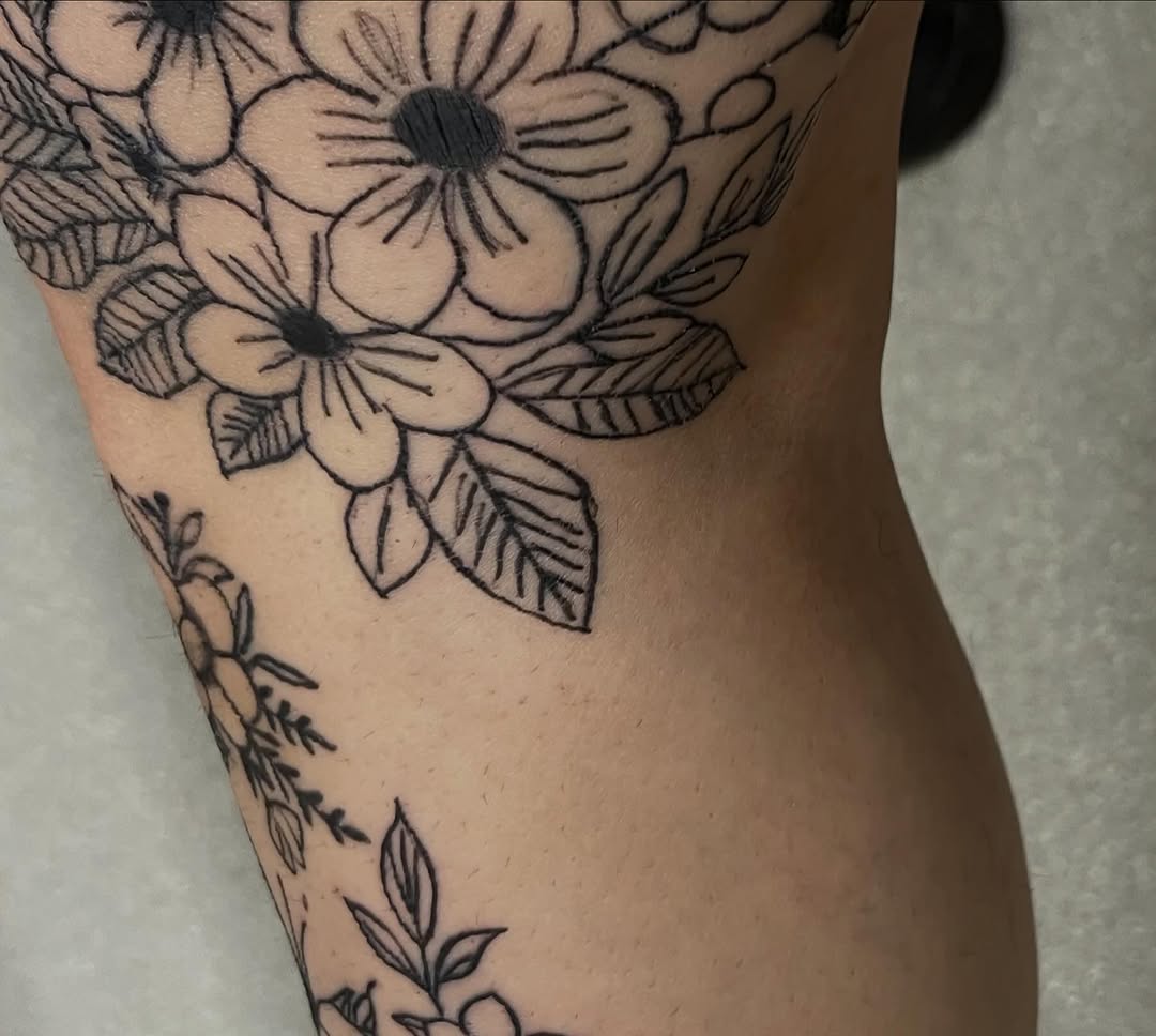Floral arrangement dotwork tattoo on the thigh by The feminine ink
