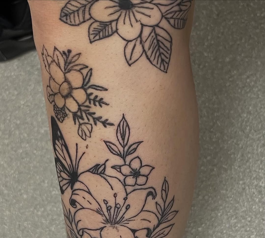 Flowers and butterfly fine line tattoo on the forearm by The feminine ink