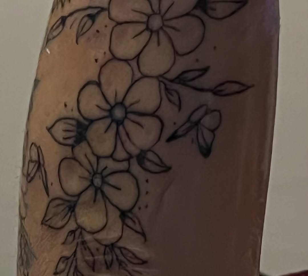 Flowers and butterfly fine line tattoo on the forearm by The feminine ink