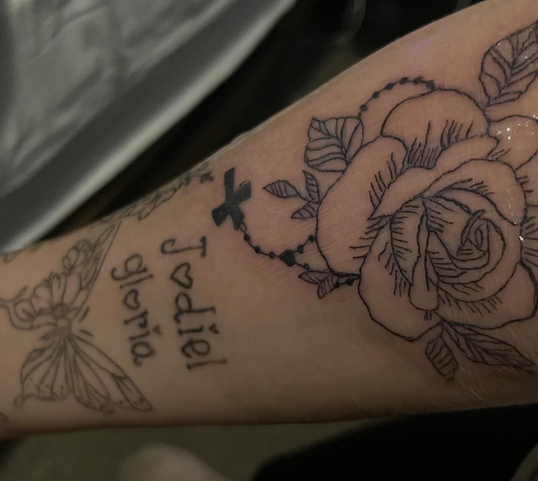 Rose with rosary and names dotwork tattoo on the forearm by The feminine ink