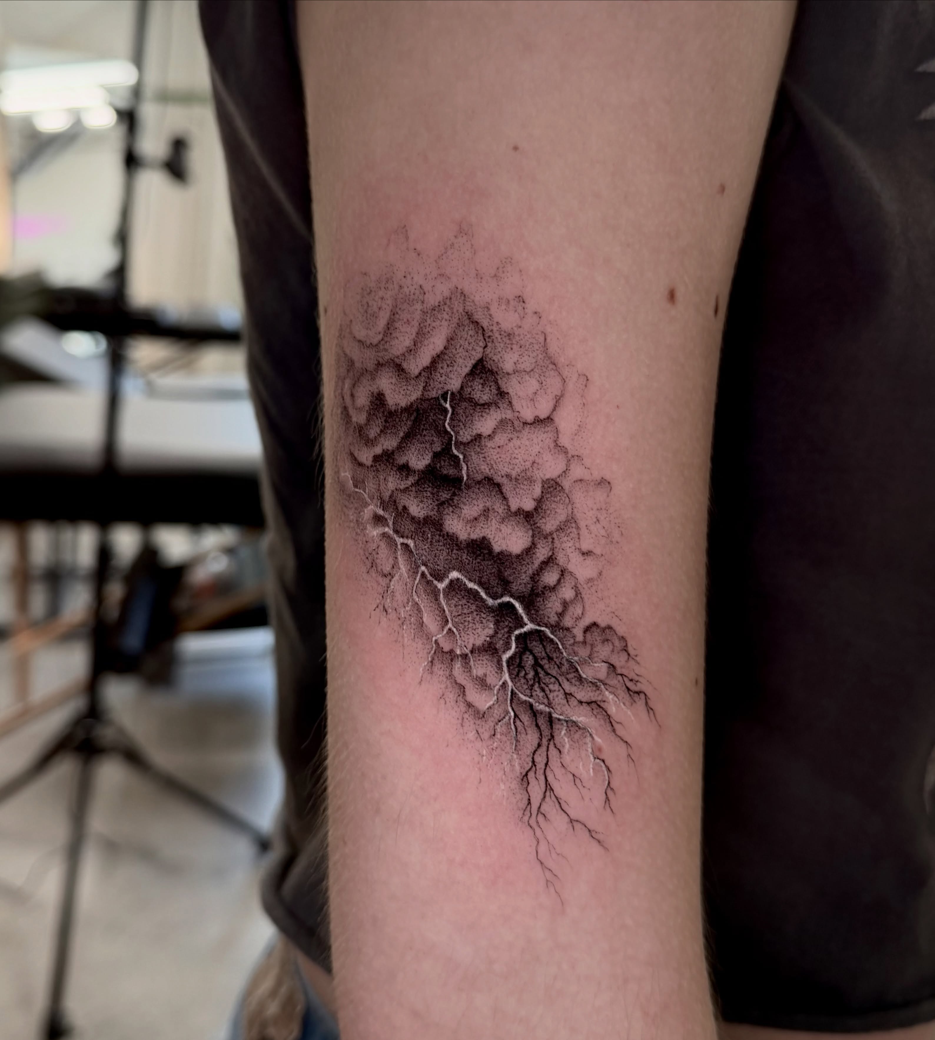 Lightning storm dotwork tattoo on the forearm by Anna