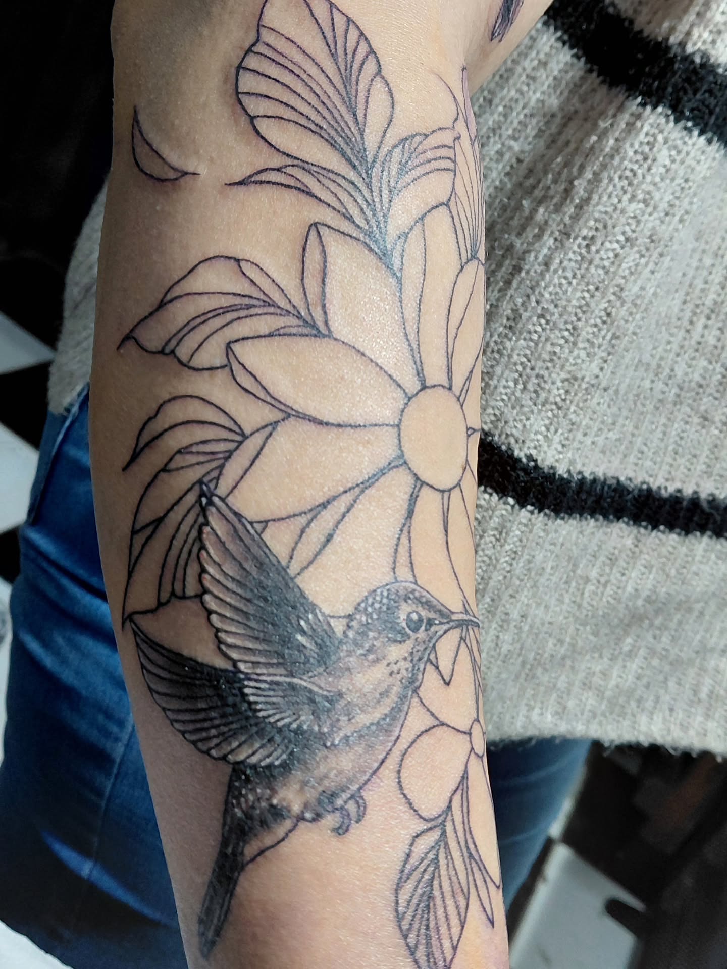 Bird and flowers black and grey tattoo on the forearm by Jose Rodriguez