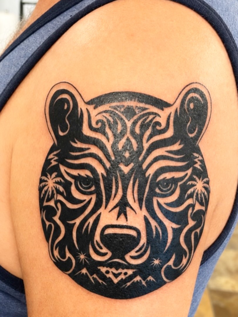Bear head with tribal patterns tribal tattoo on the shoulder by Stoney