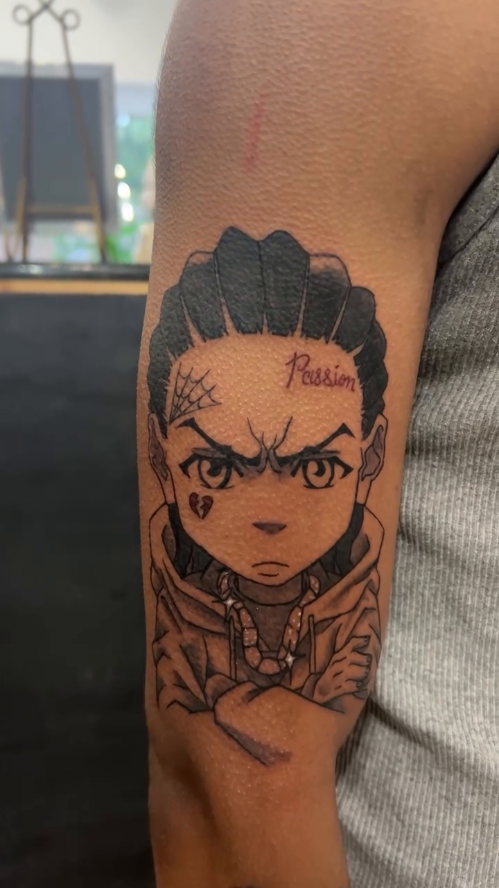 Huey Freeman from The Boondocks anime tattoo on the forearm by @delitotattoos