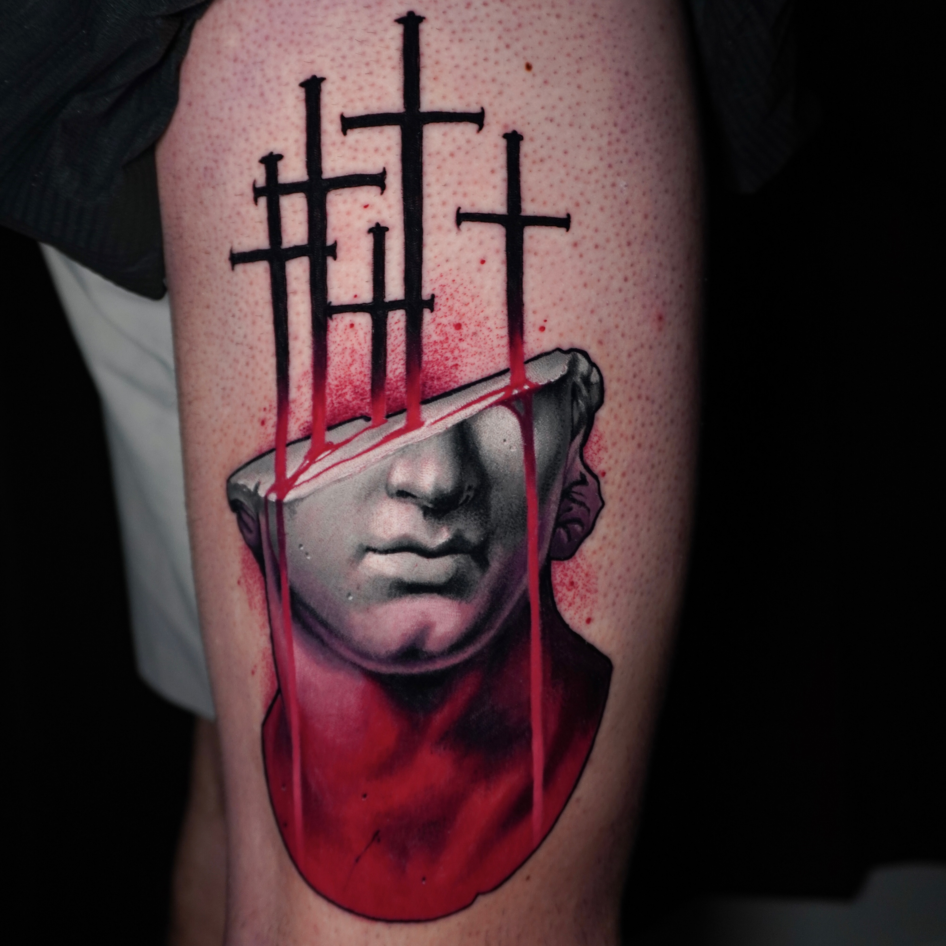 Broken statue head with crosses sketch tattoo on the forearm by Andrey