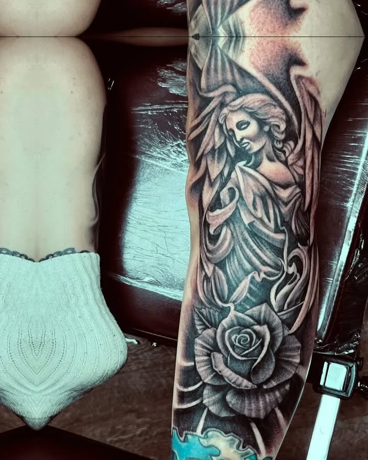 Angel and rose realism tattoo on the forearm by Watson Gutkowski