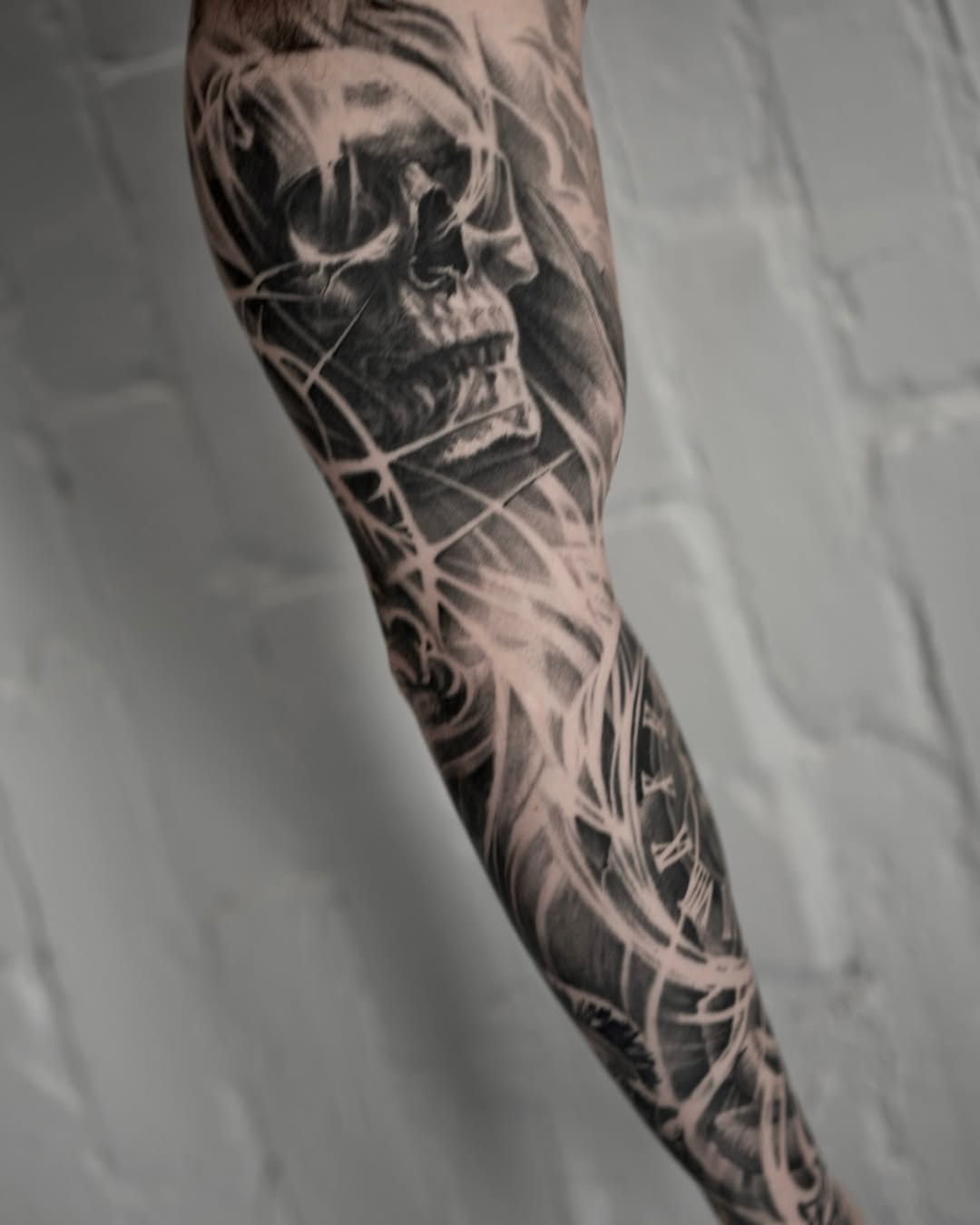 Skull and clock realism tattoo on the forearm by Mark Vata