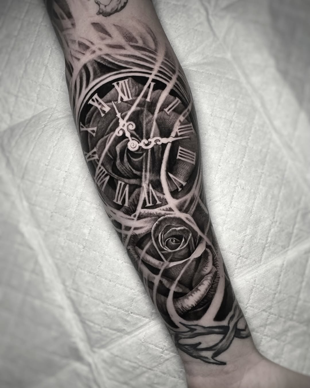 Clock and rose realism tattoo on the forearm by Mark Vata