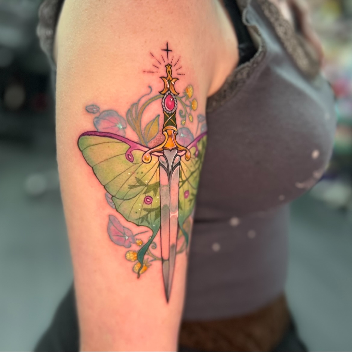 Sword and butterfly watercolor tattoo on the forearm by Maara Martinez