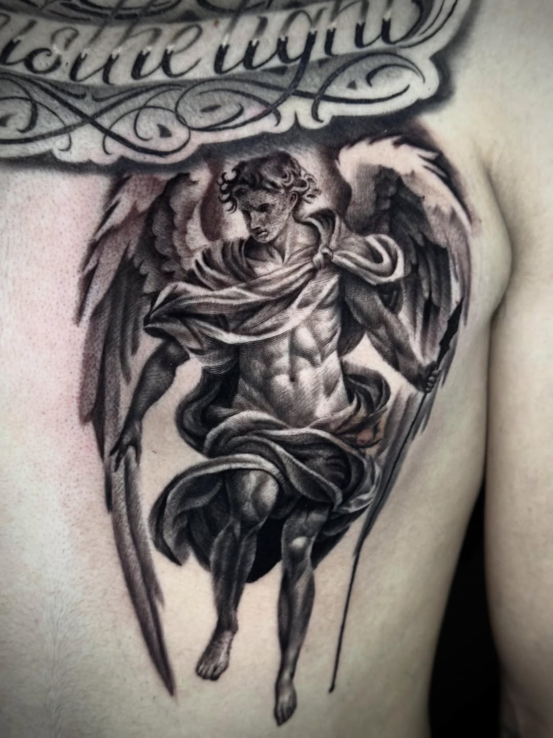 Angel with wings and sword realism tattoo on the chest by Tony Garcia