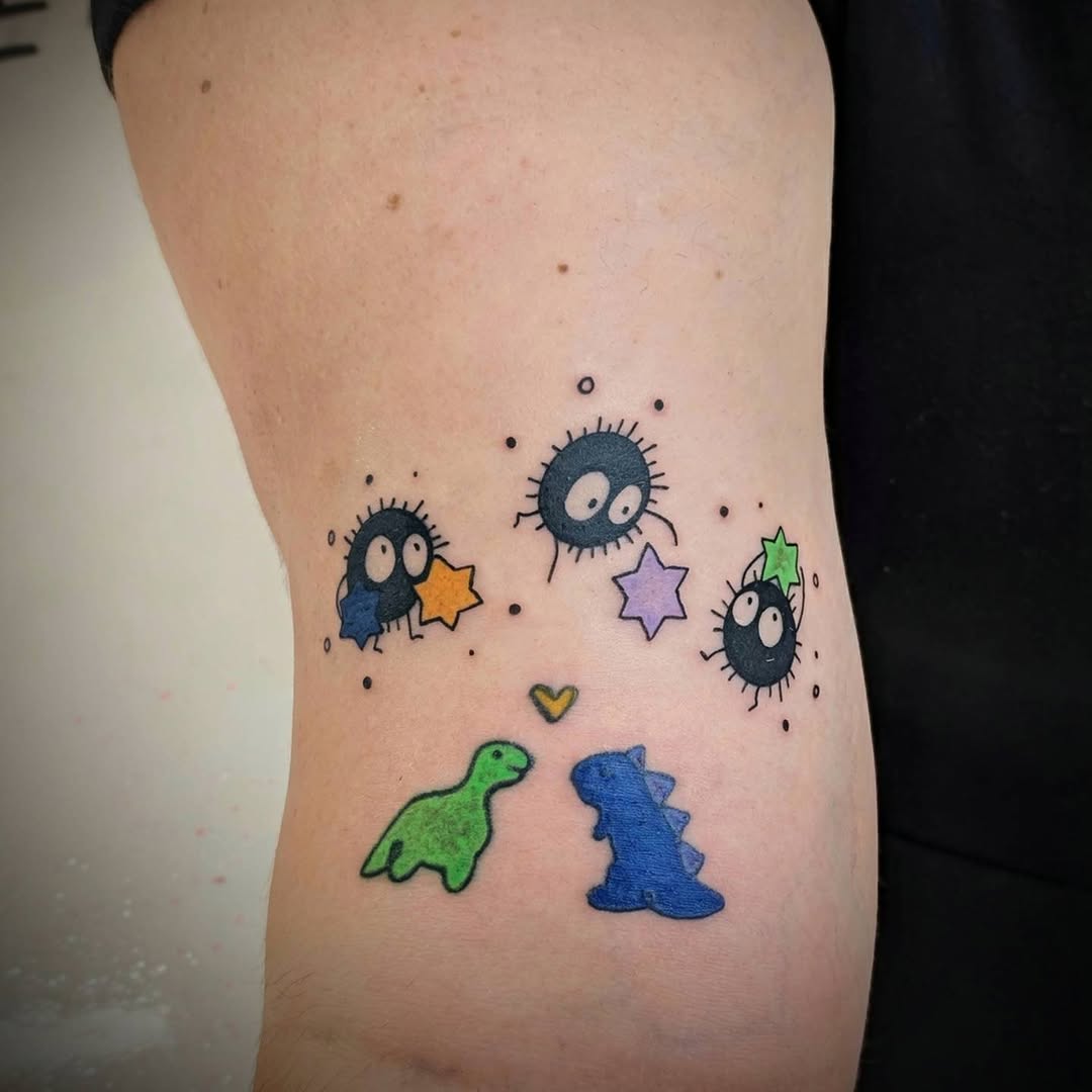 Soot sprites and dinosaurs new school tattoo on the ribs by Rhiannon