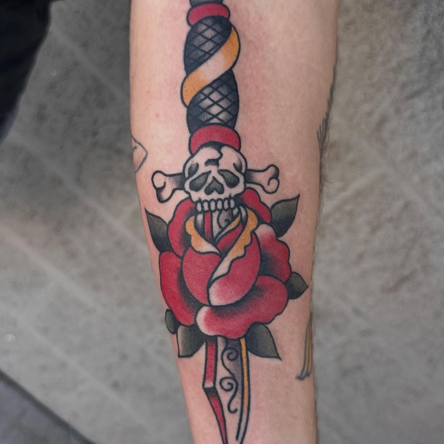 Sword and rose American traditional tattoo on the forearm by bryce duval