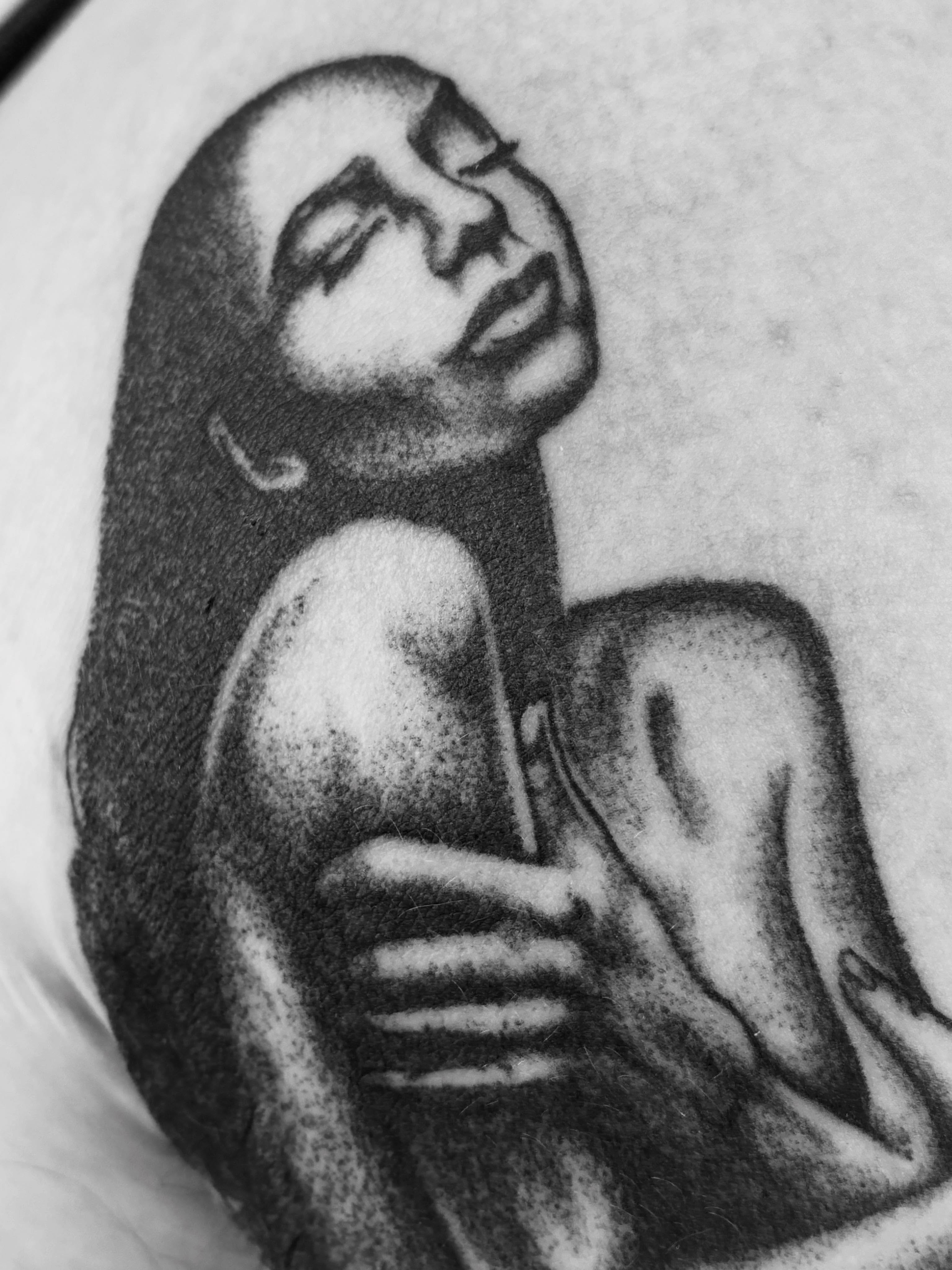 Nude woman dotwork tattoo on the upper arm by Zachary R Bobkoff