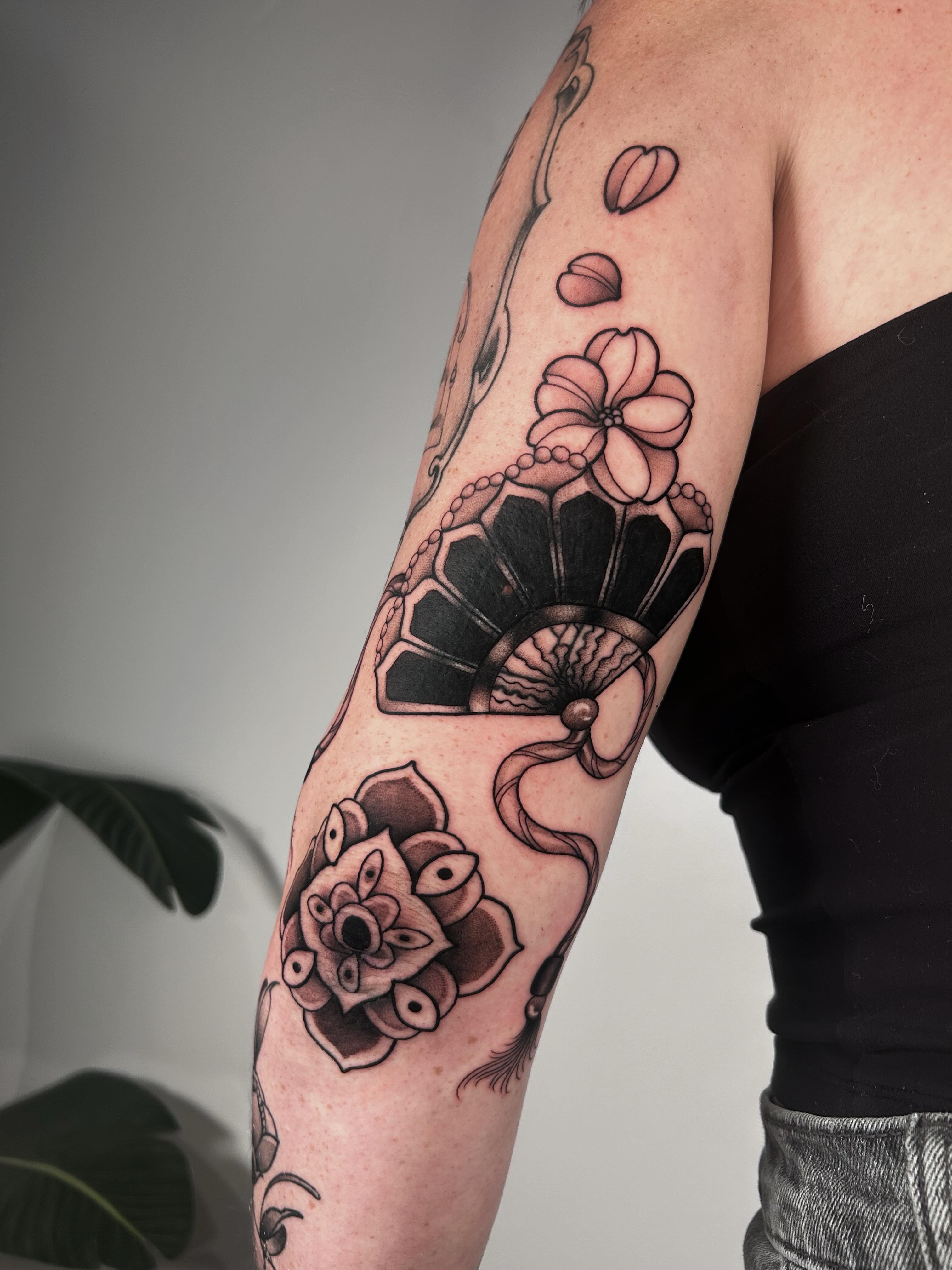 Floral arrangement geometric tattoo on the forearm by Salt Lake City tattoo artist