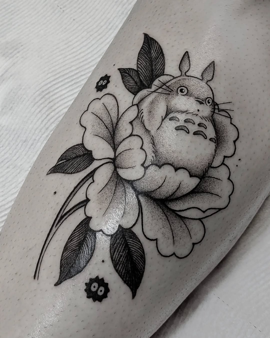 Totoro and flower fine line tattoo on the forearm by Joshua Harkey