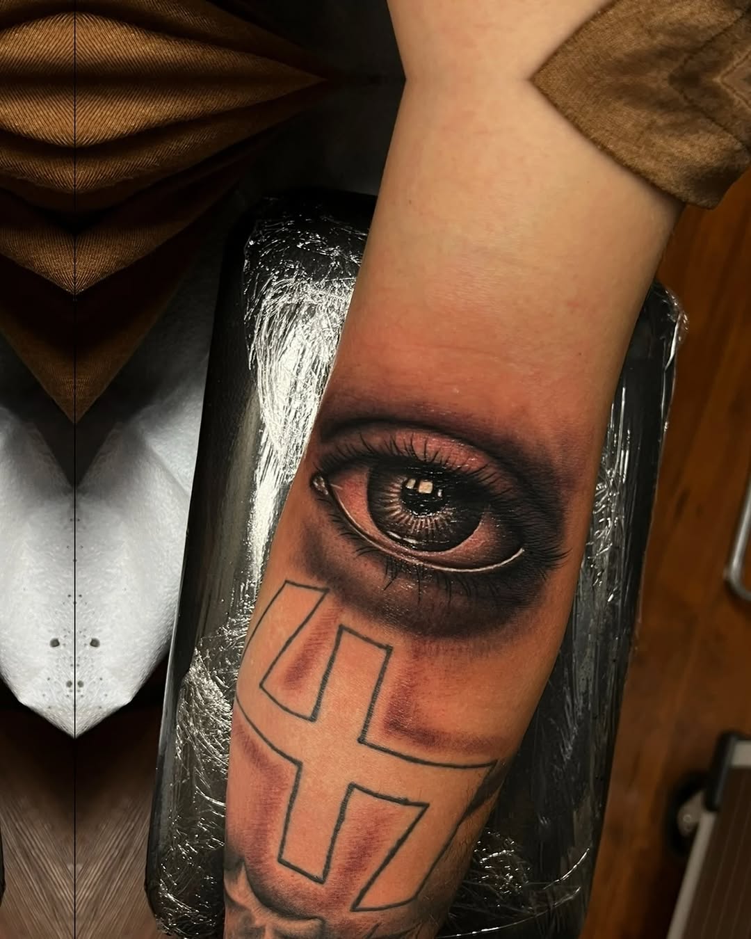Eye and symbol surrealism tattoo on the forearm by Magdalena Davis