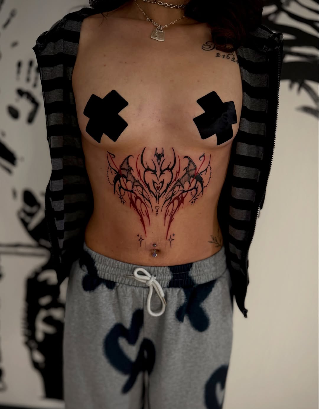 Abstract tribal heart with wings cyber sigilism tattoo on the torso by K Valentine