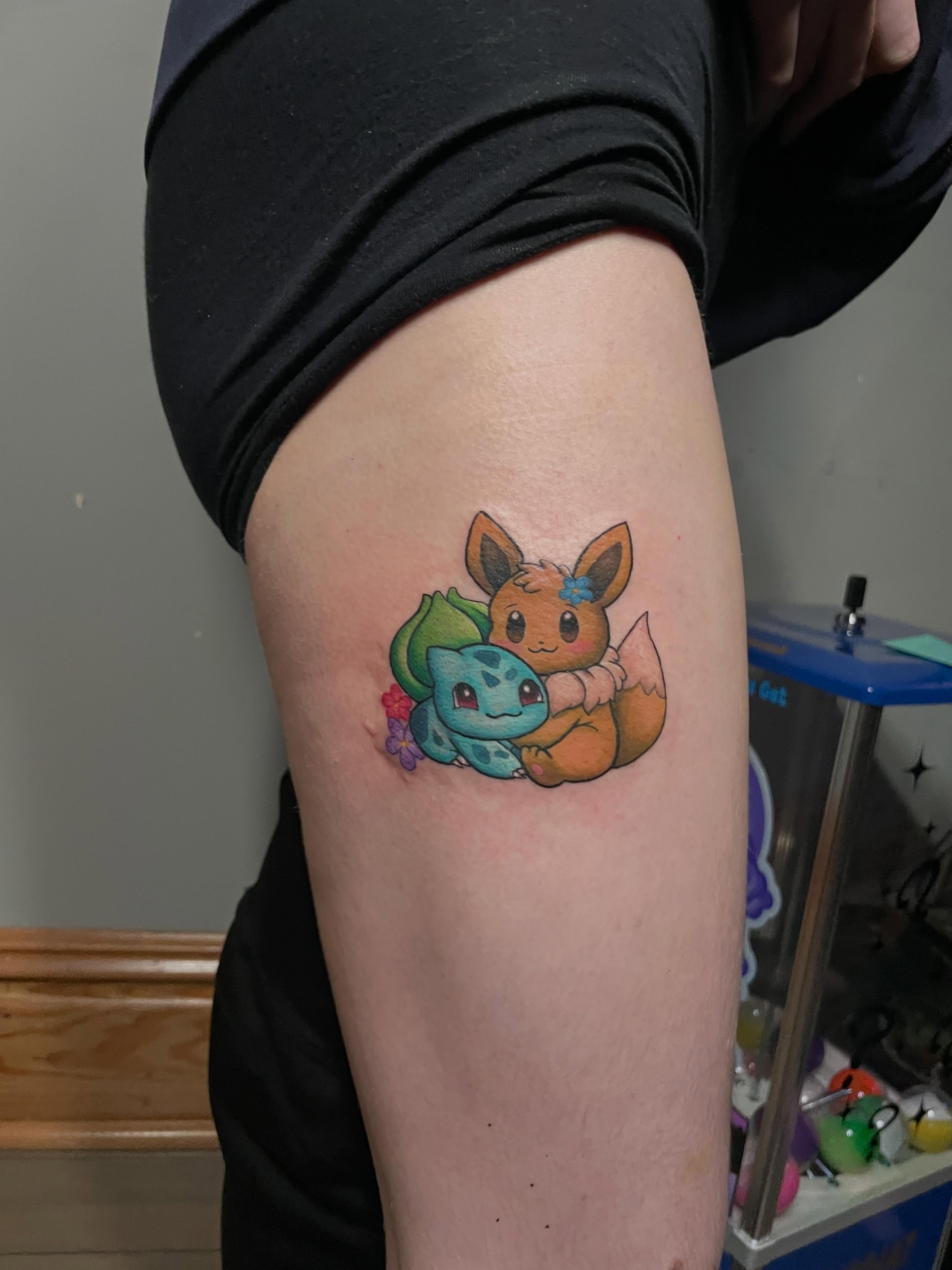 Eevee and Bulbasaur dotwork tattoo on the thigh by Hannah Copeskey