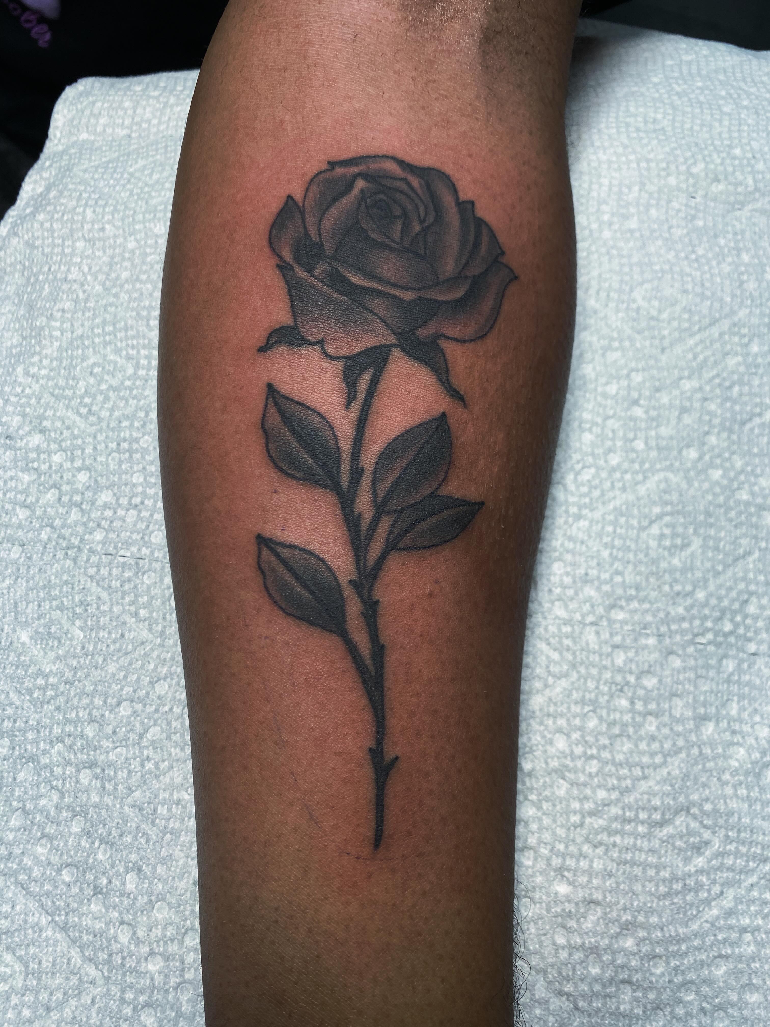 Rose black and grey tattoo on the forearm by Houston tattoo artist