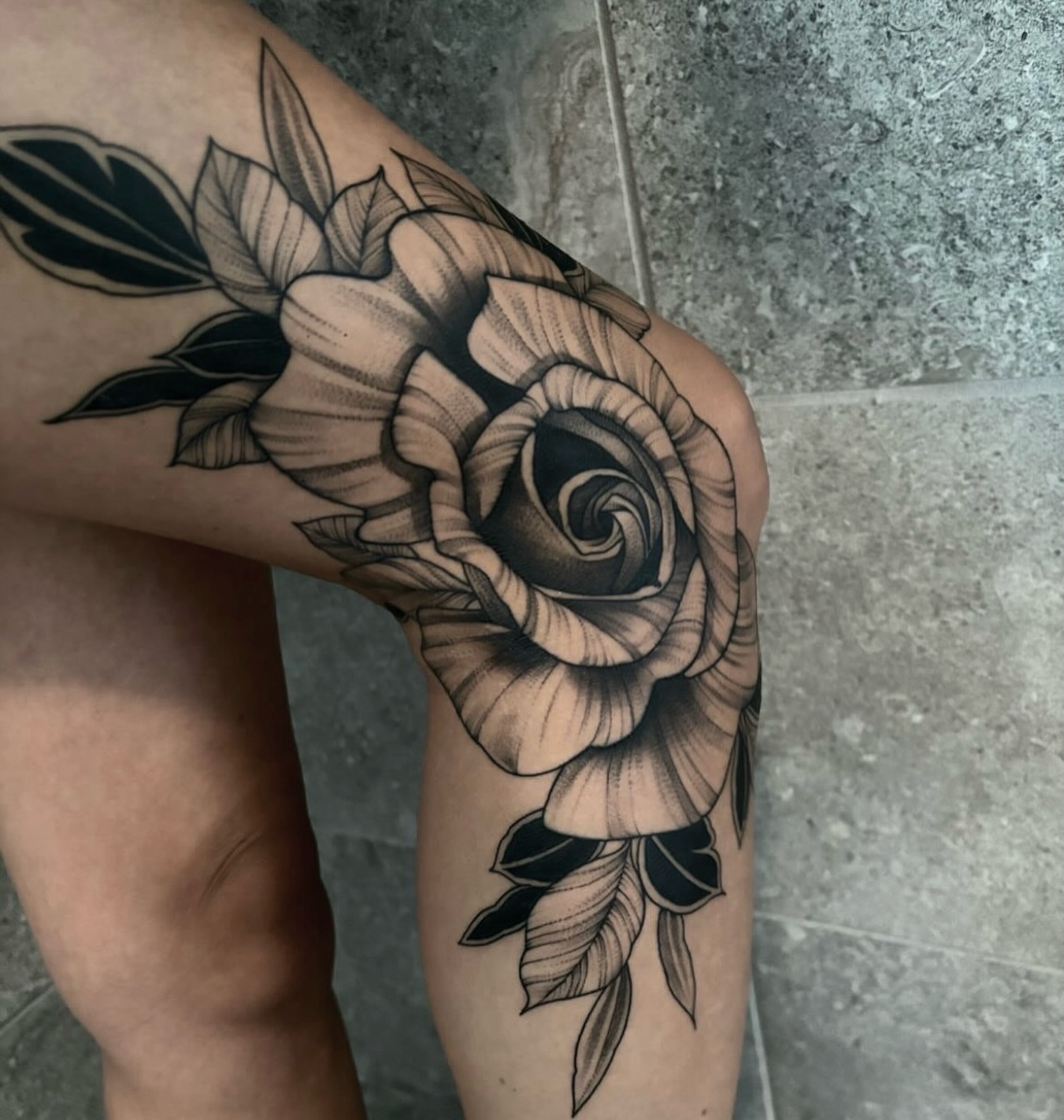 Rose black and grey tattoo on the thigh by Sterling Grice