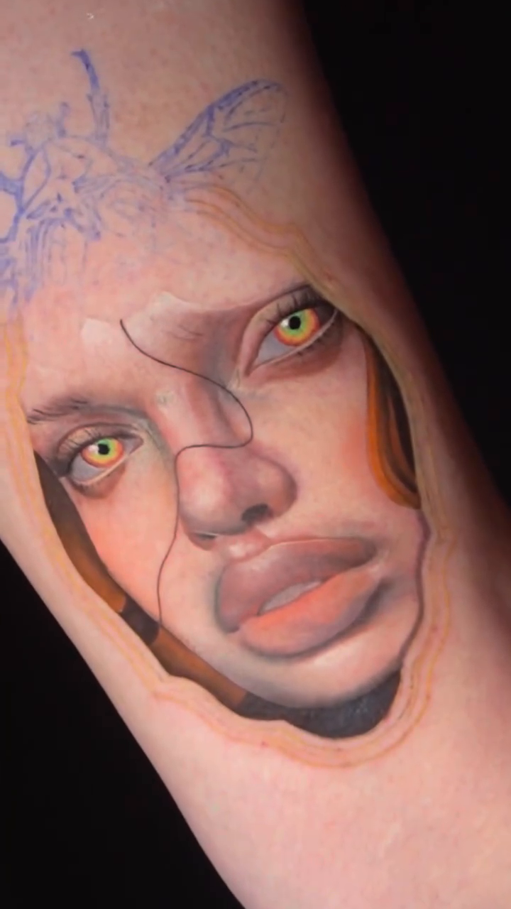Surrealism tattoo on the upper arm by orlando