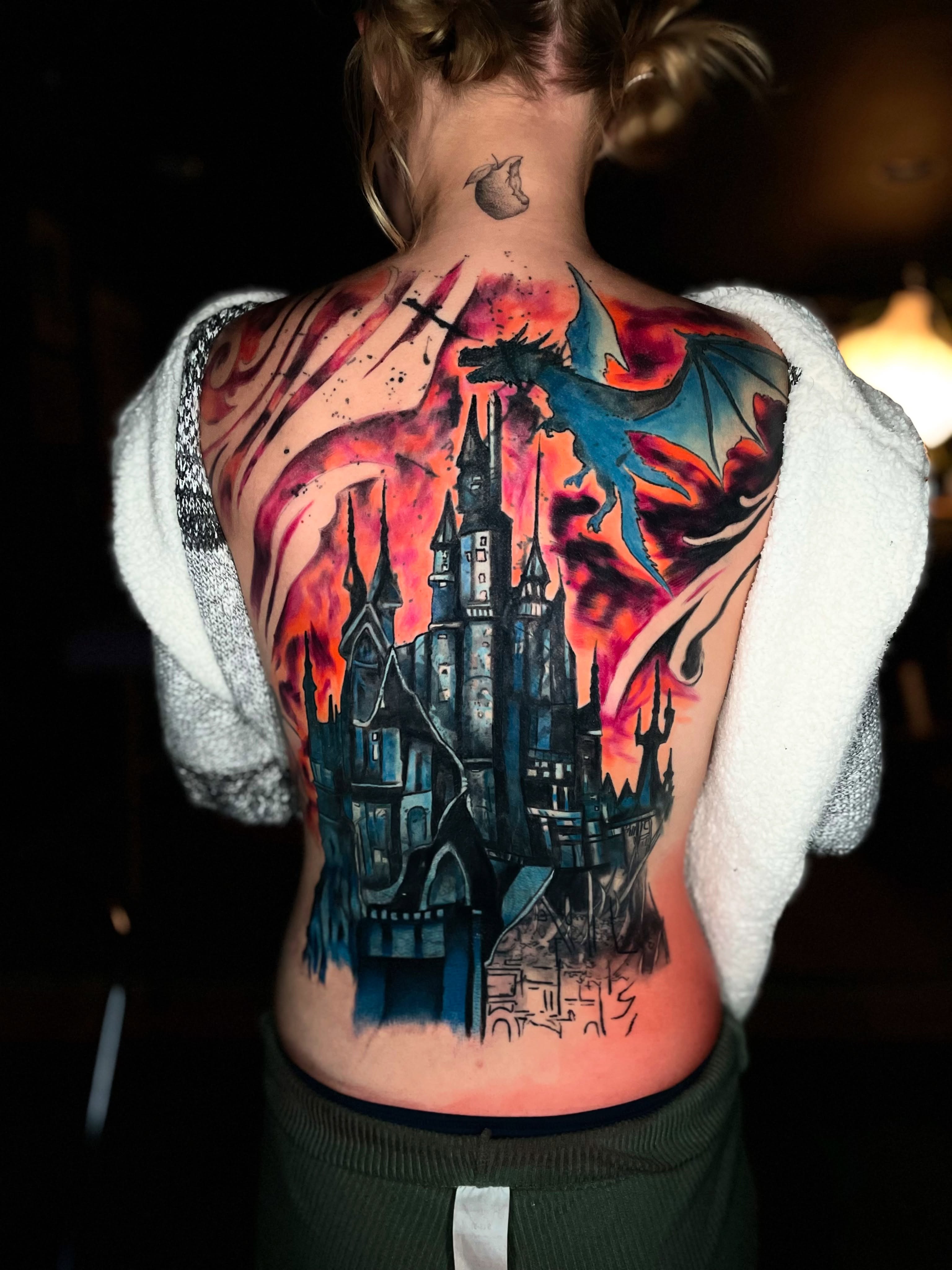Castle and dragon watercolor tattoo on the back by Dean Rogers