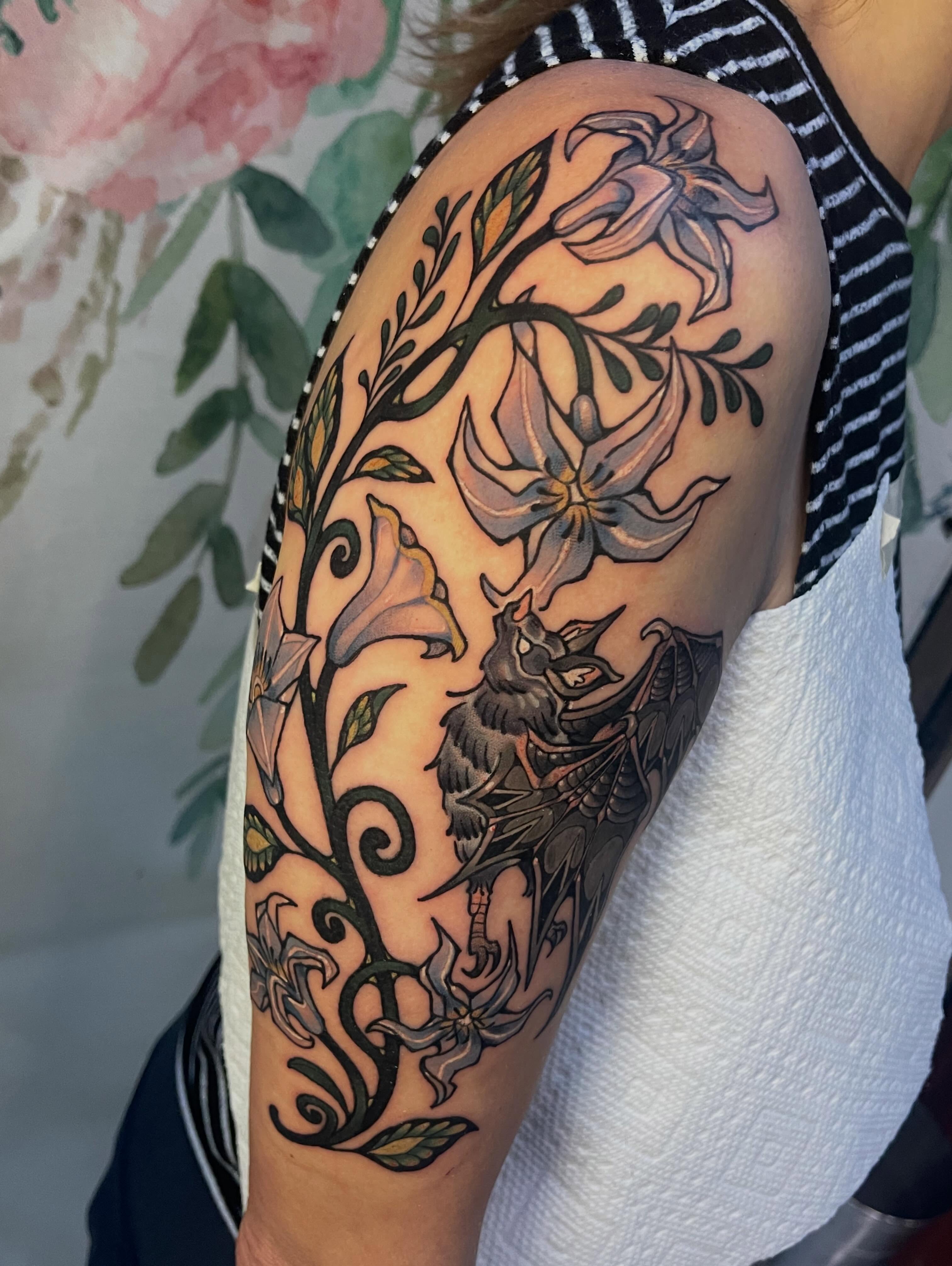 Lily and dragon American traditional tattoo on the shoulder by 🌿Izzy🌿