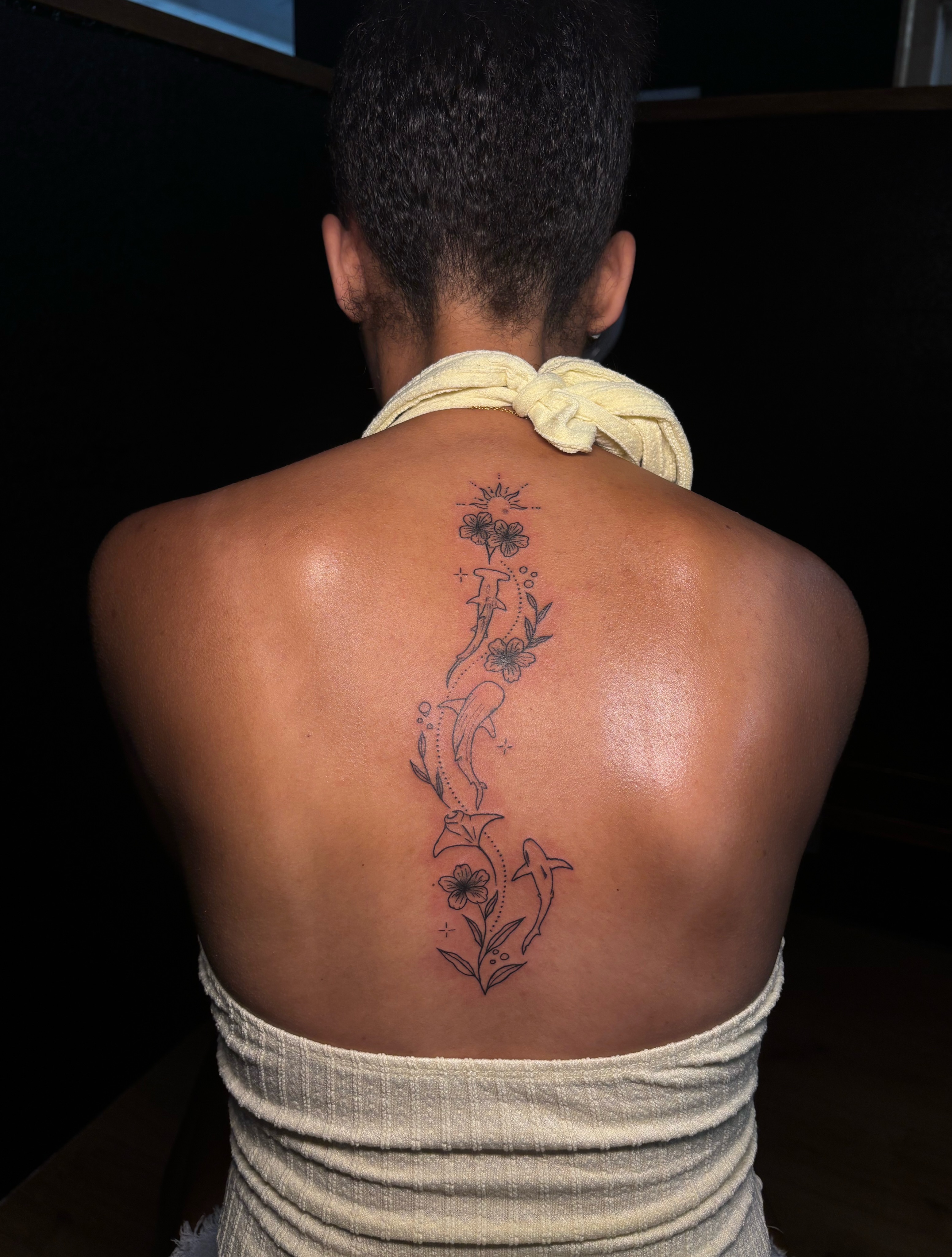 Dolphins and flowers black and grey tattoo on the back by JT.tattoos