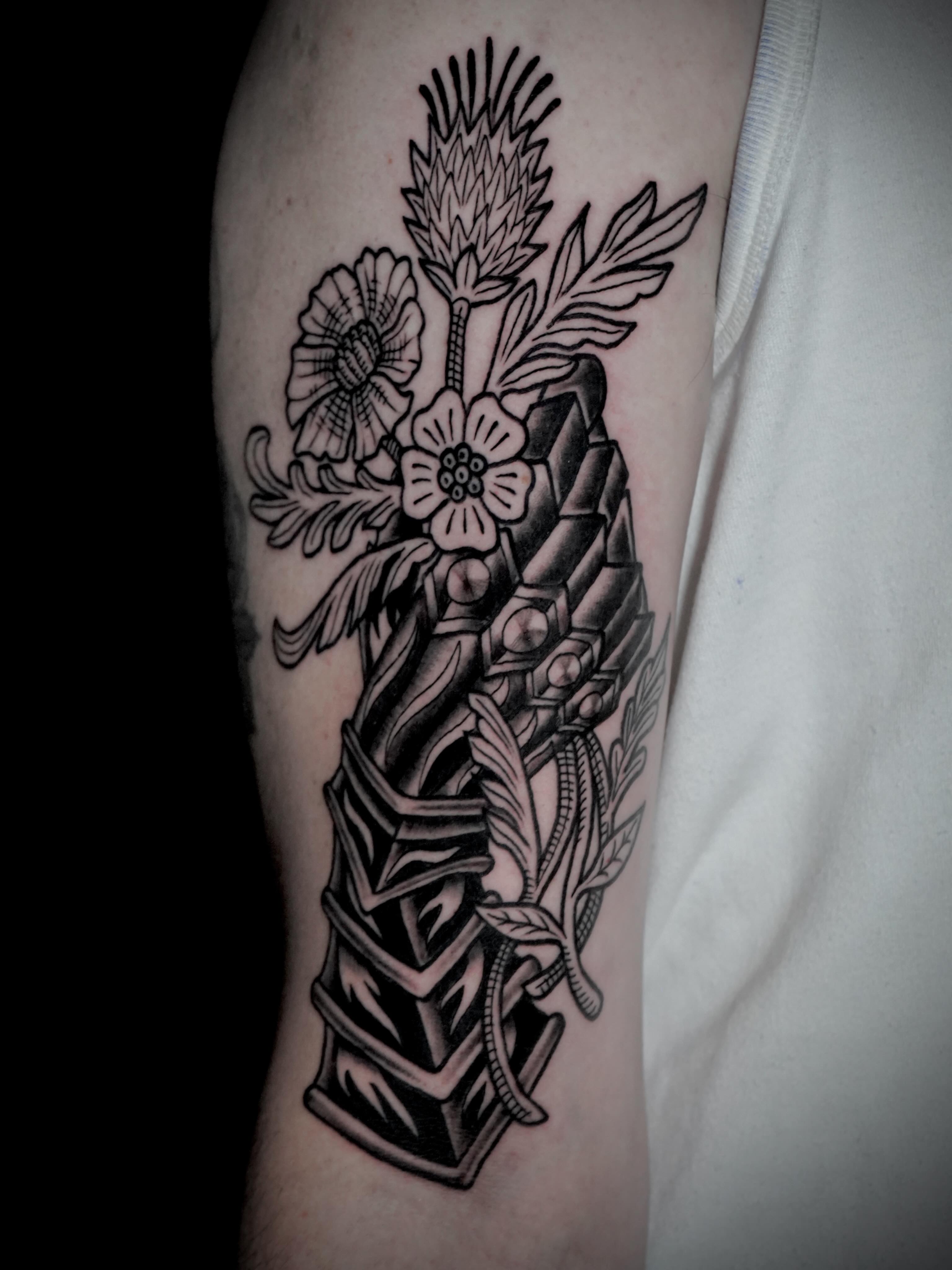 Floral arrangement black and grey tattoo on the forearm by Gina Carlson