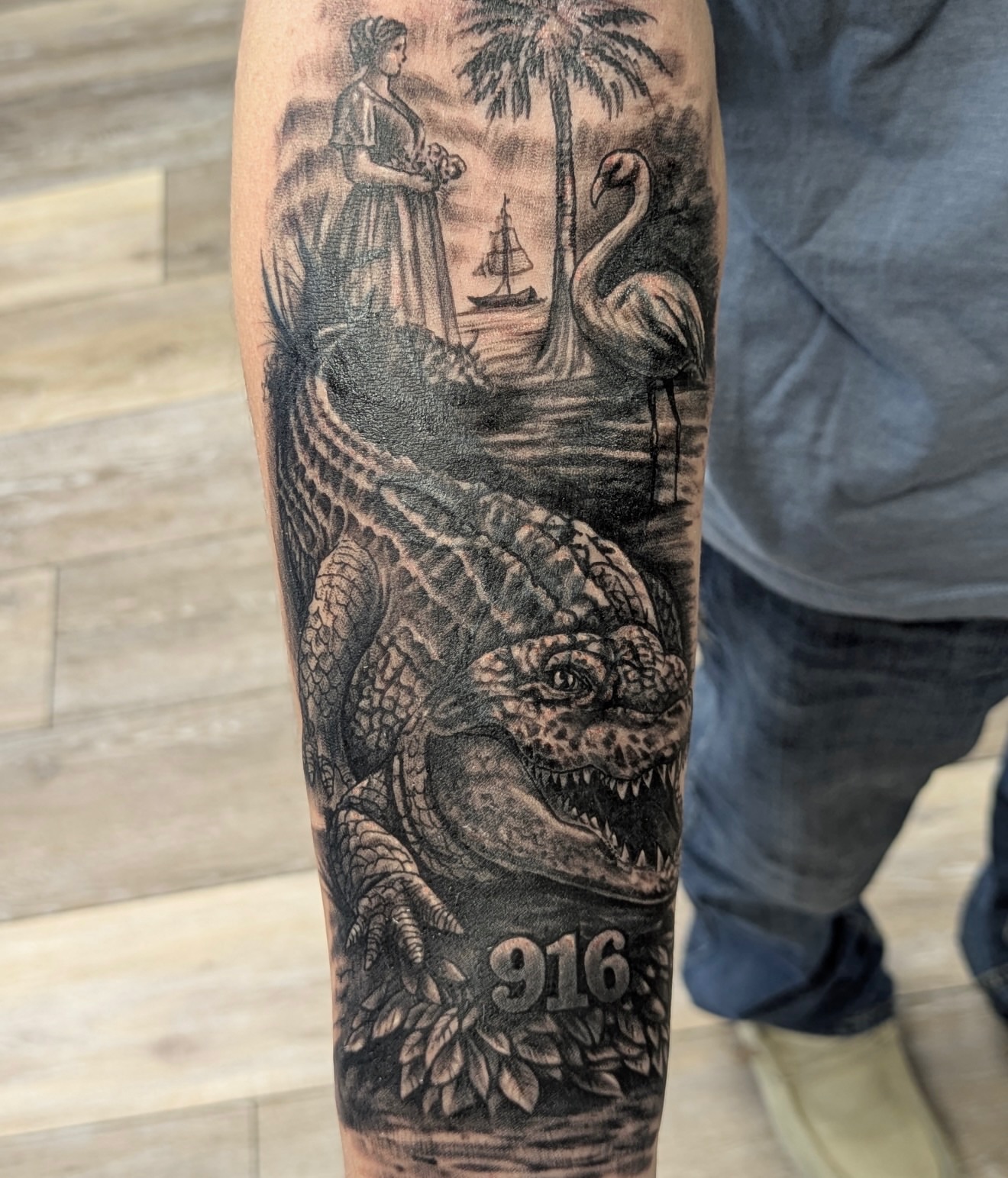 Alligator and woman realism tattoo on the forearm by Buddy K.
