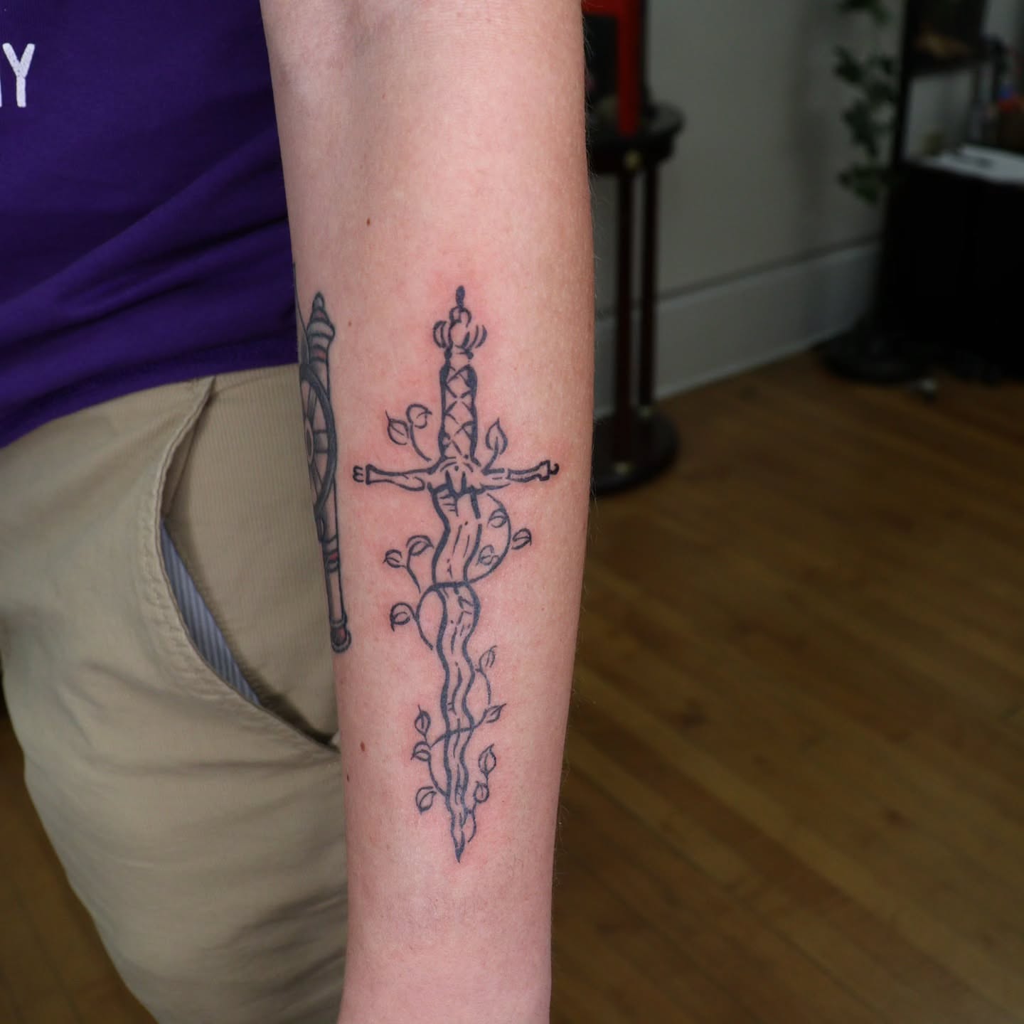 Sword and vines black and grey tattoo on the forearm by Veronika Lipchak