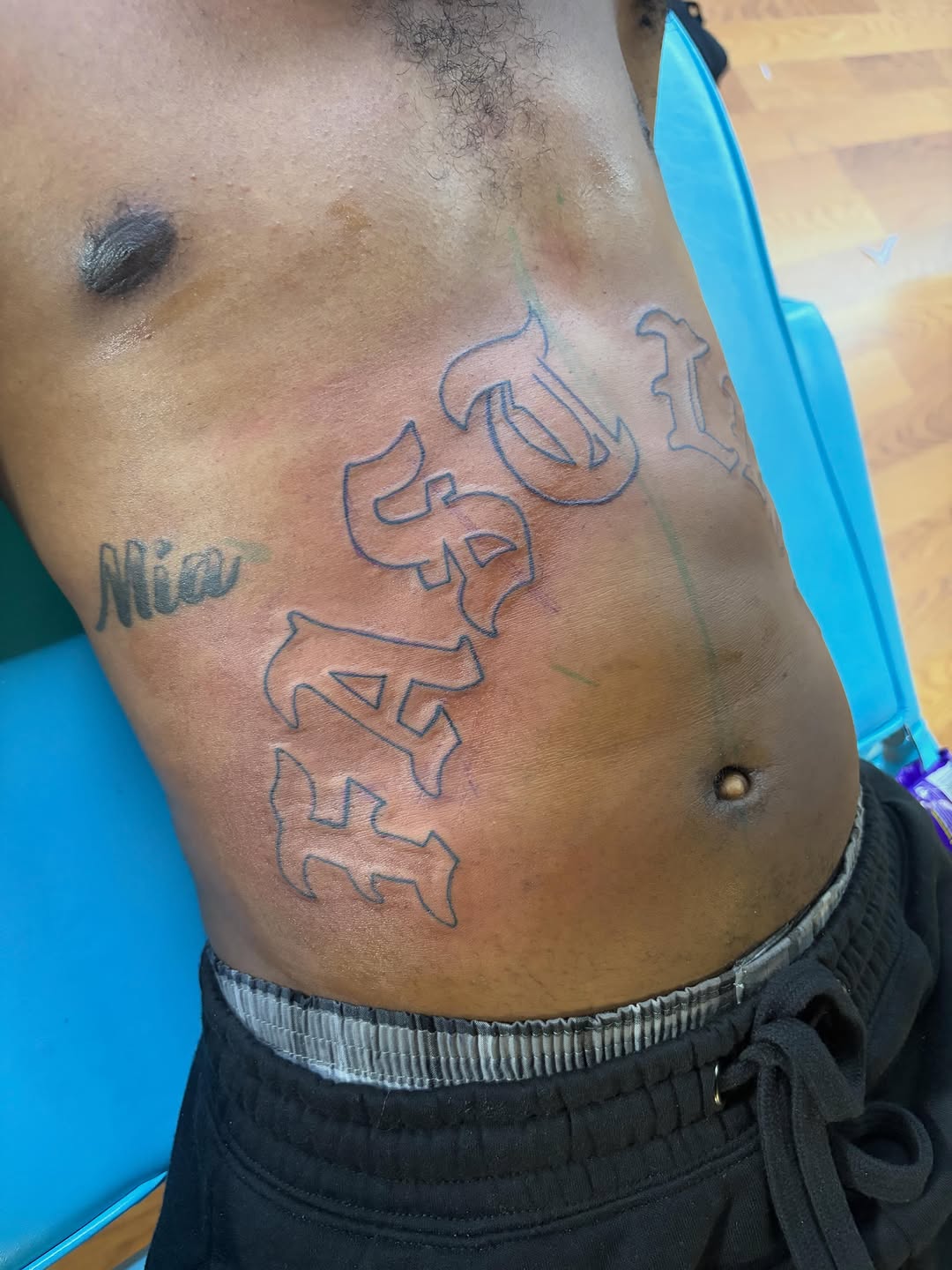 Old english lettering Chicano tattoo on the chest by Jae the artist🫡