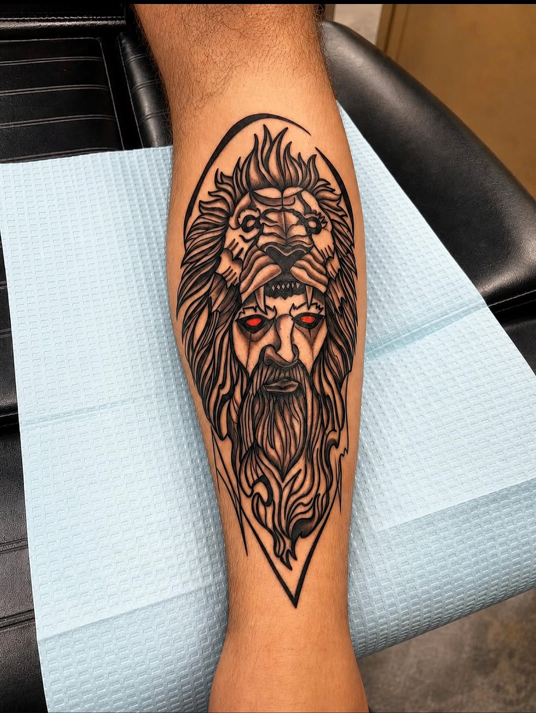 Man wearing lion head surrealism tattoo on the forearm by Stoney