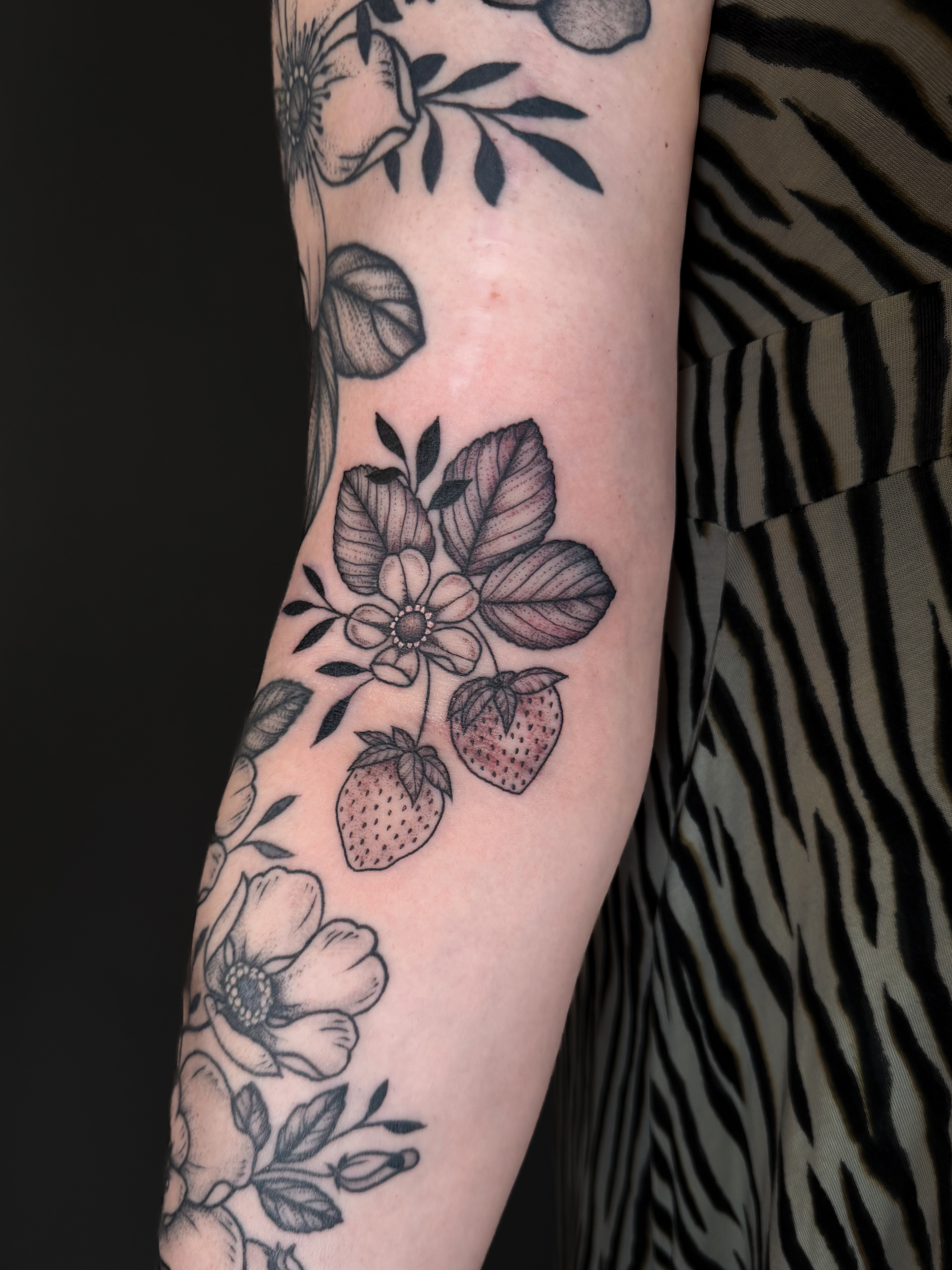 Strawberries and flowers black and grey tattoo on the forearm by Hannah, Portland, Oregon