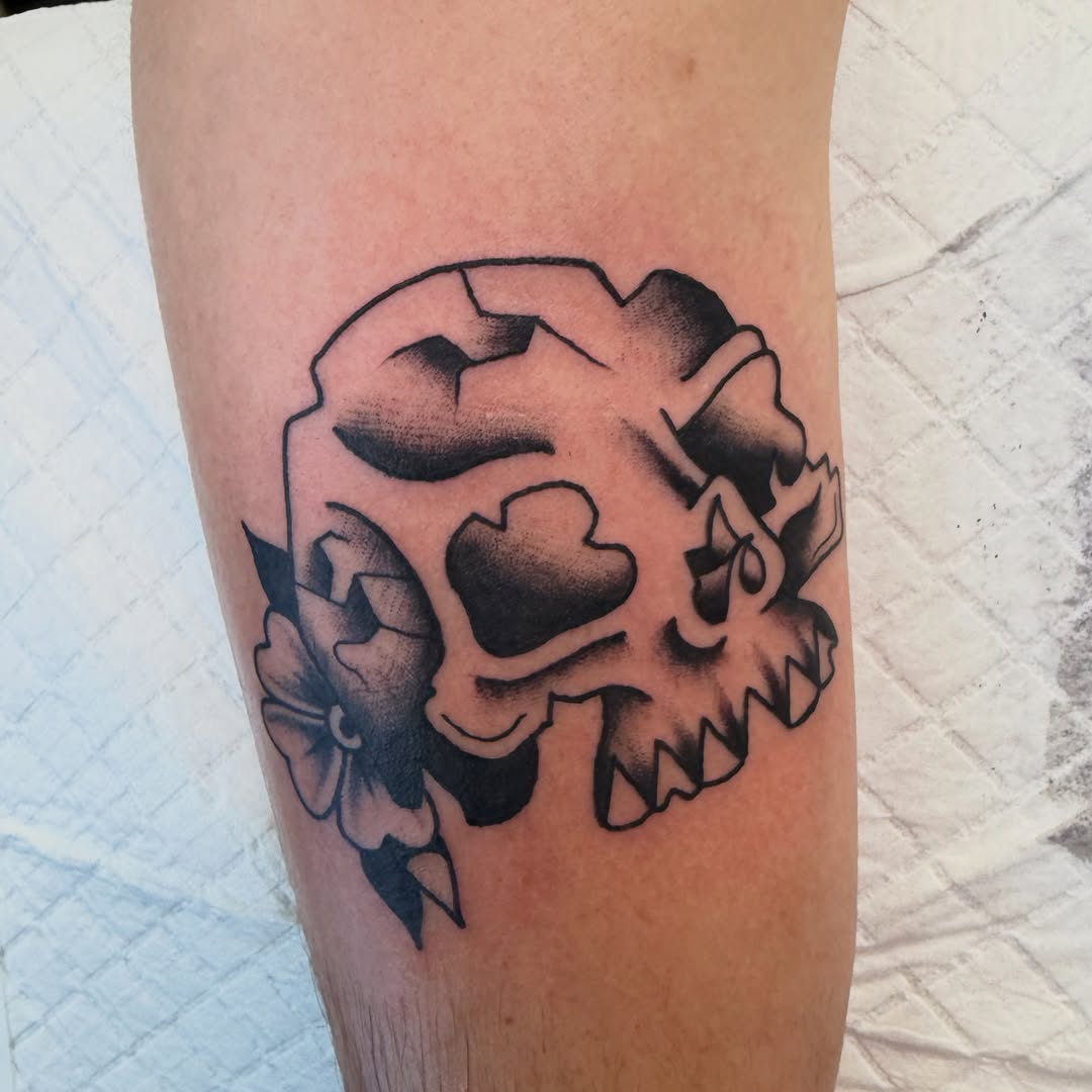 Skull and flower realism tattoo on the forearm by Nick Tumminello