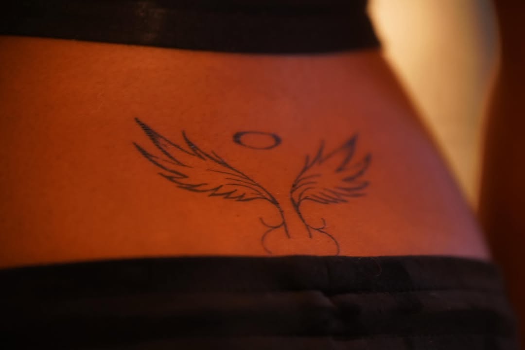 Angel wings with halo cyber sigilism tattoo on the torso by rylie :P